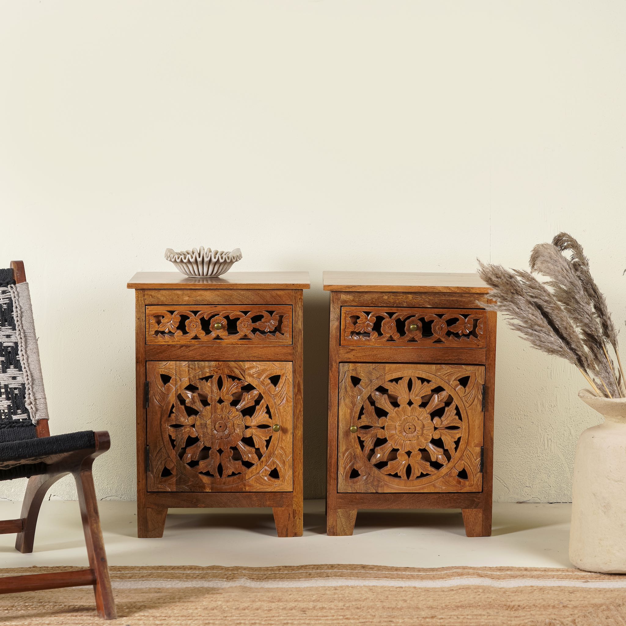 Pair of mango wood night stands with hand carved floral and geometric detailing, warm teak finish; elegant hand carved furniture, 45 × 35 × 65 cm.