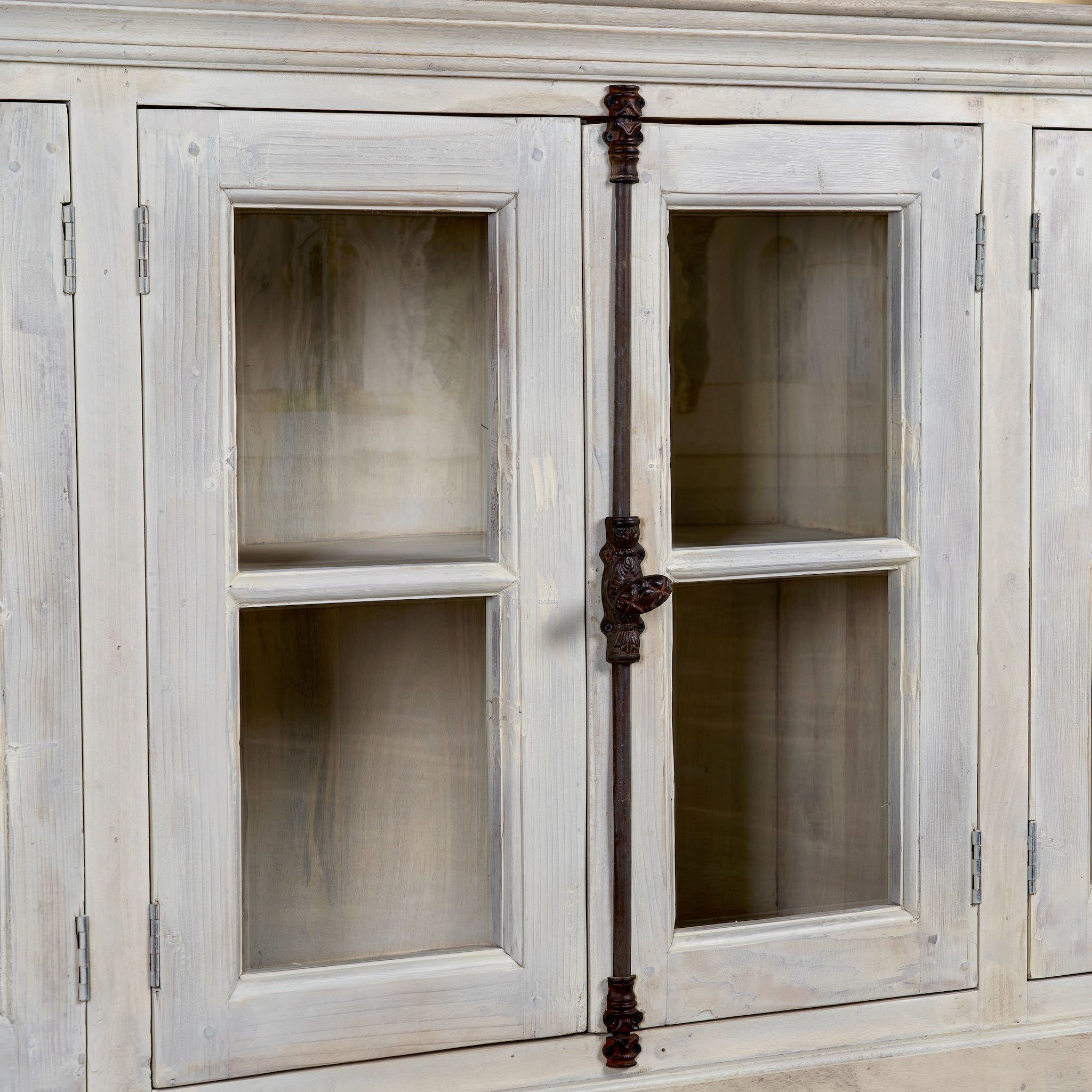Close up image of a sandblasted reclaimed wood sideboard in Ibiza style with four glass-panelled doors, vintage Mediterranean furniture, 263×45×100 cm.