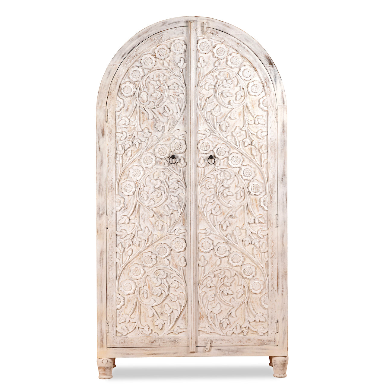 White background image of an arched wooden wardrobe made of mango wood with hand-carved floral details; hand carved wooden furniture in Ibiza style, 190 × 100 × 40 cm.