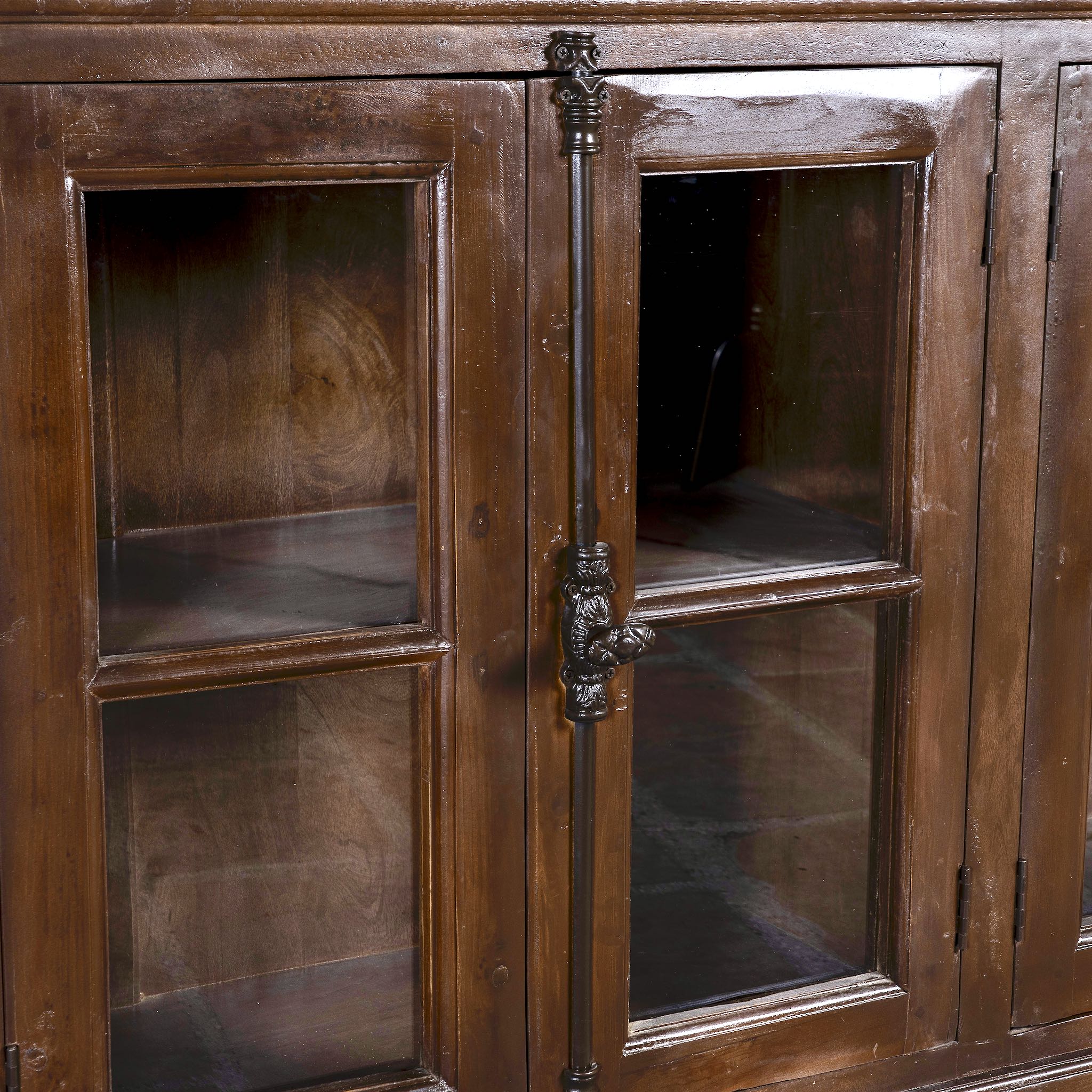 Close up image of a reclaimed teak furniture sideboard with glass doors, rustic living room furniture with boho style, 257 × 46 × 100 cm.