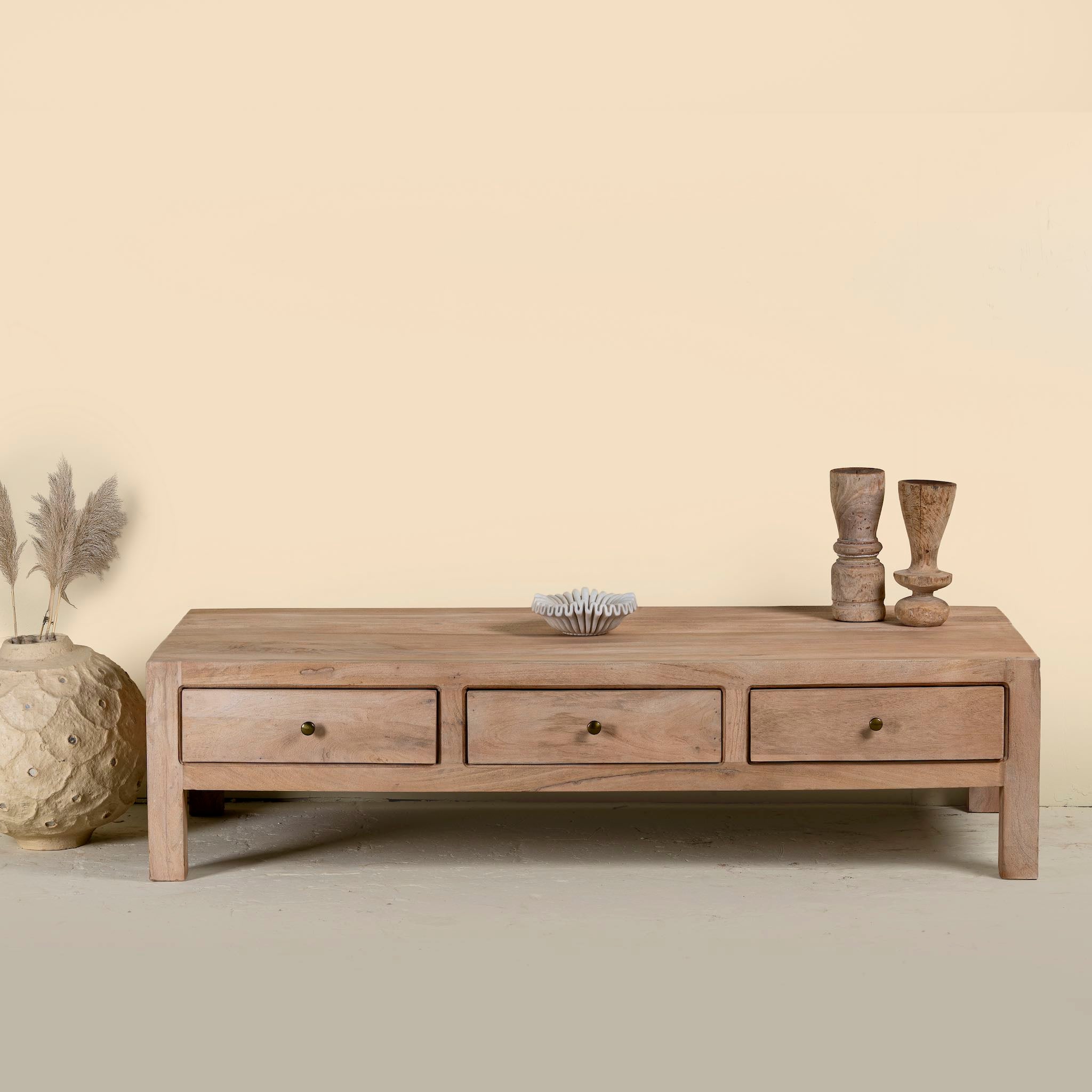 Minimalistic wooden coffee table made from reclaimed wood with three drawers; natural finish, 150 × 60 × 45 cm.