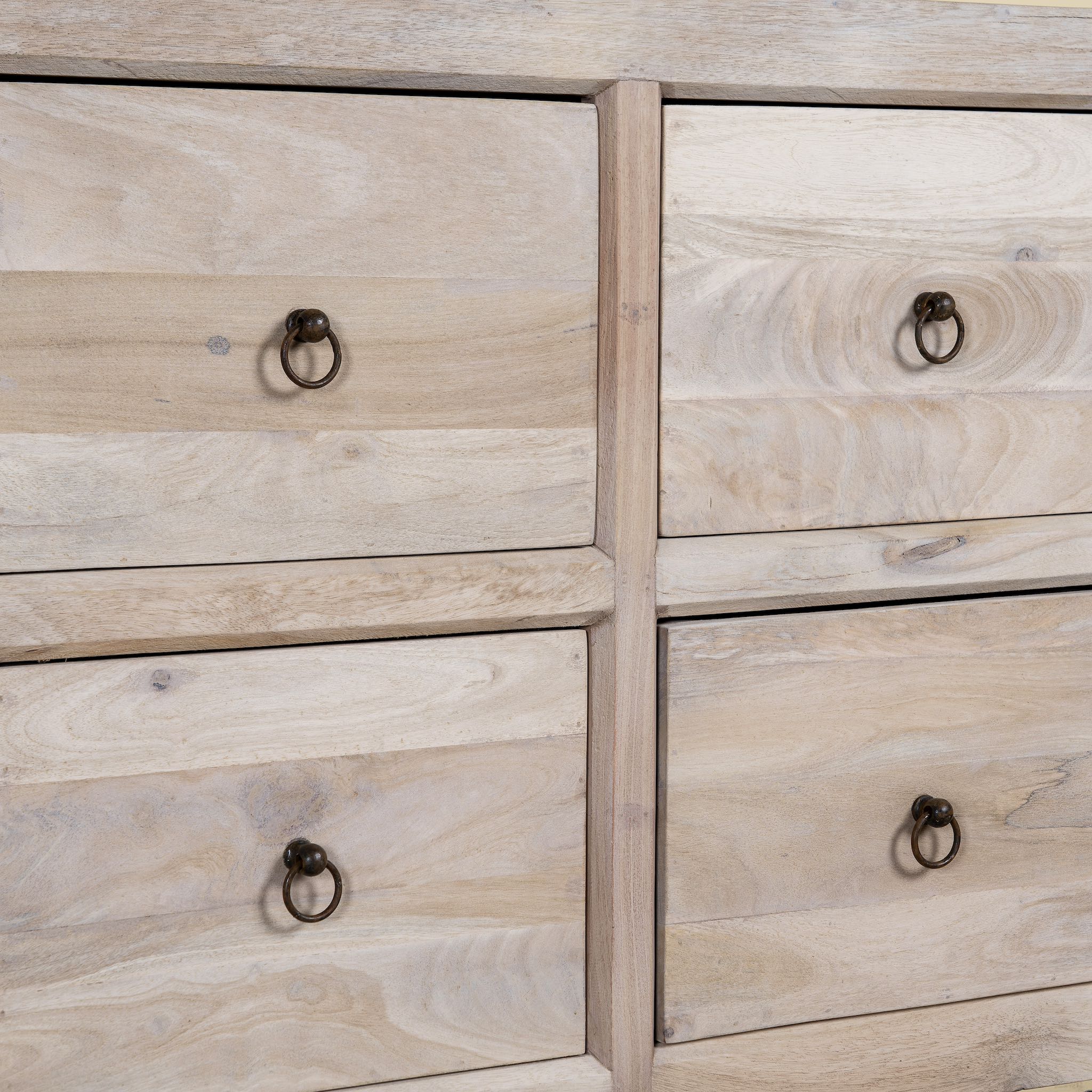 Close up image of a Ibiza style chest of drawers made from sandblasted reclaimed wood, coastal furniture with 8 drawers and vintage metal pulls, 200 × 40 × 90 cm.