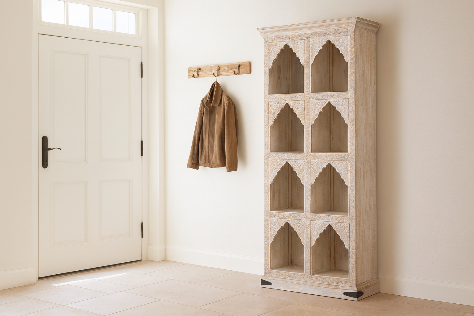 lifestyle image of a hand-carved mango wood shelving unit with Moroccan arches and whitewashed finish; perfect as an entryway shelf or display piece, 180 × 90 × 40 cm.