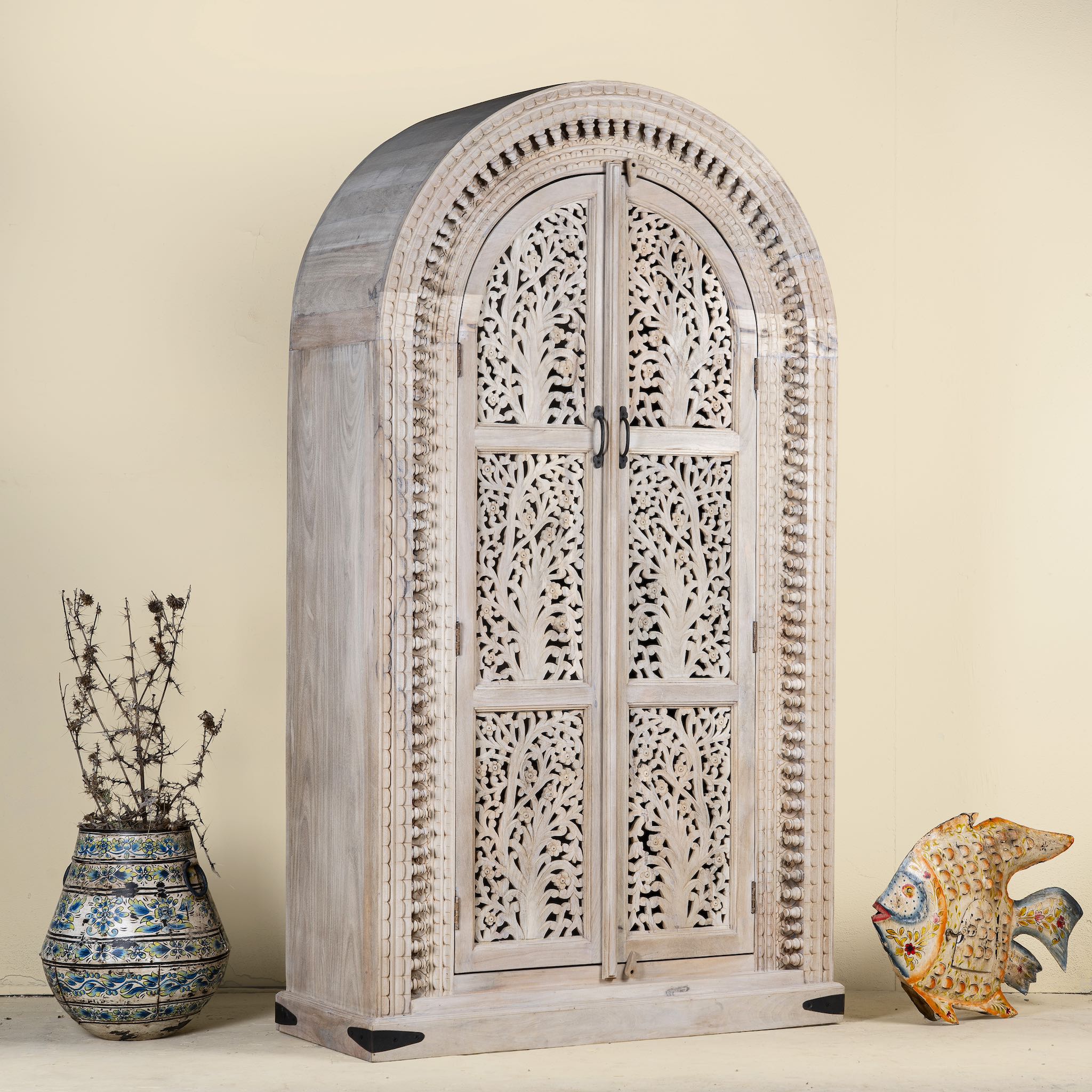 Side angle image of Artha cabinet with Tree of Life carving, a unique furniture piece from our mango wood furniture collection.