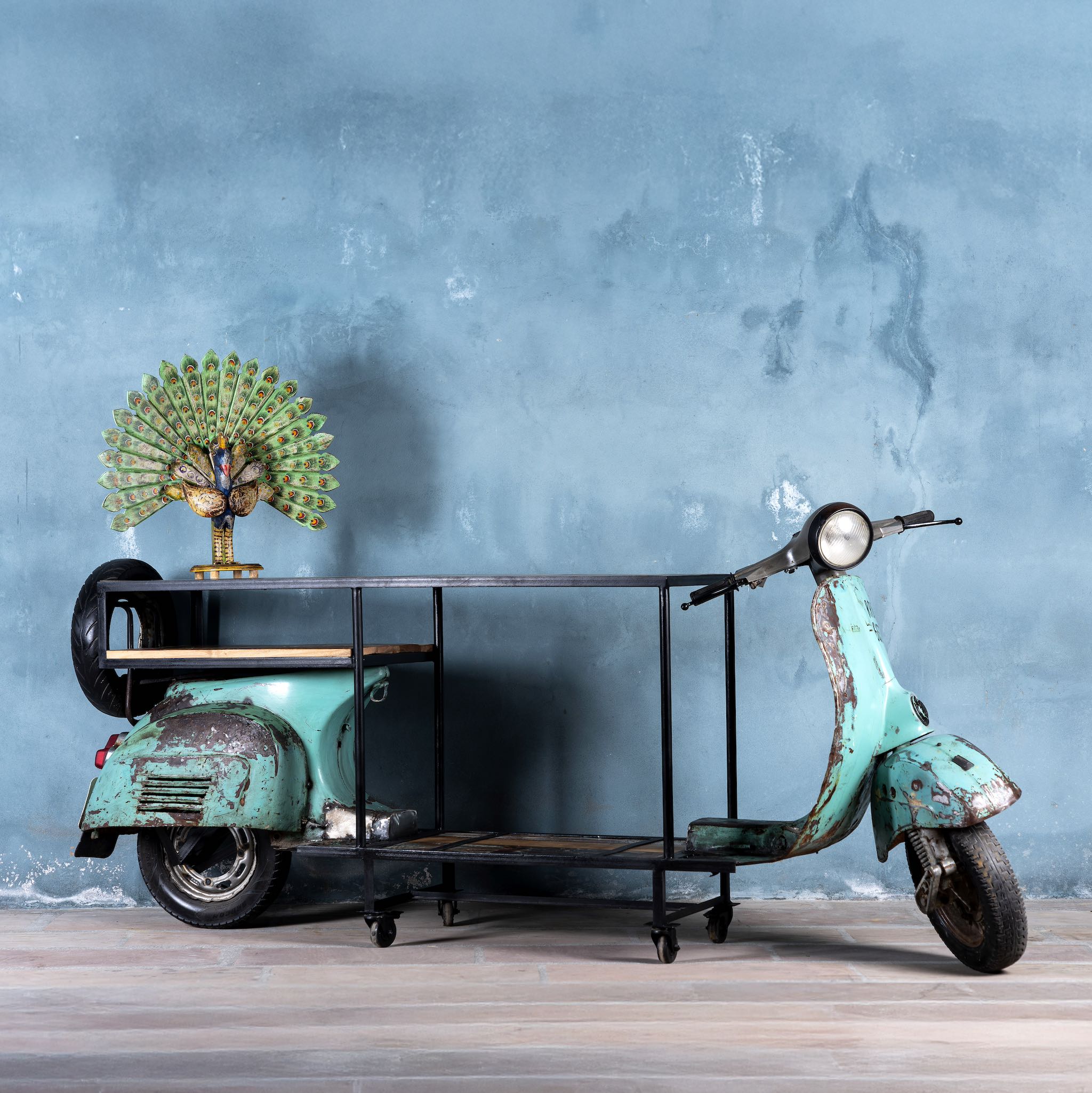 Side Image of a house bar crafted from a full vintage Indian Bajaj scooter with industrial metal frame and wooden shelves, featuring original patina and retro design elements."