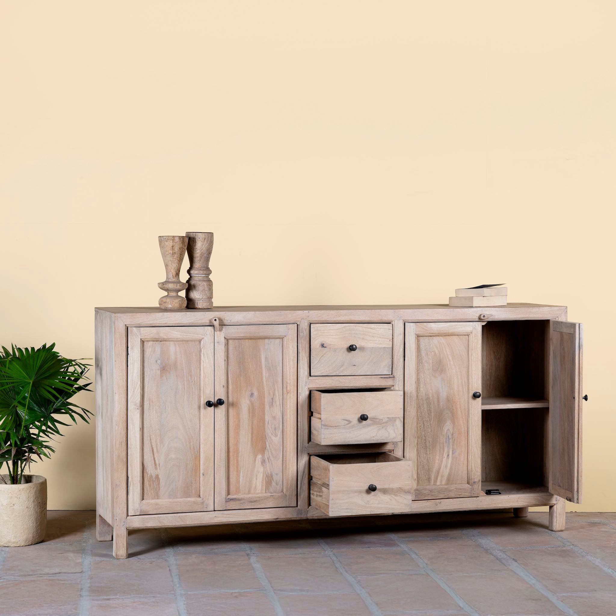 Open drawers and doors image of a sandblasted wood sideboard with drawers and cabinets, living room furniture in relaxed Ibiza style.