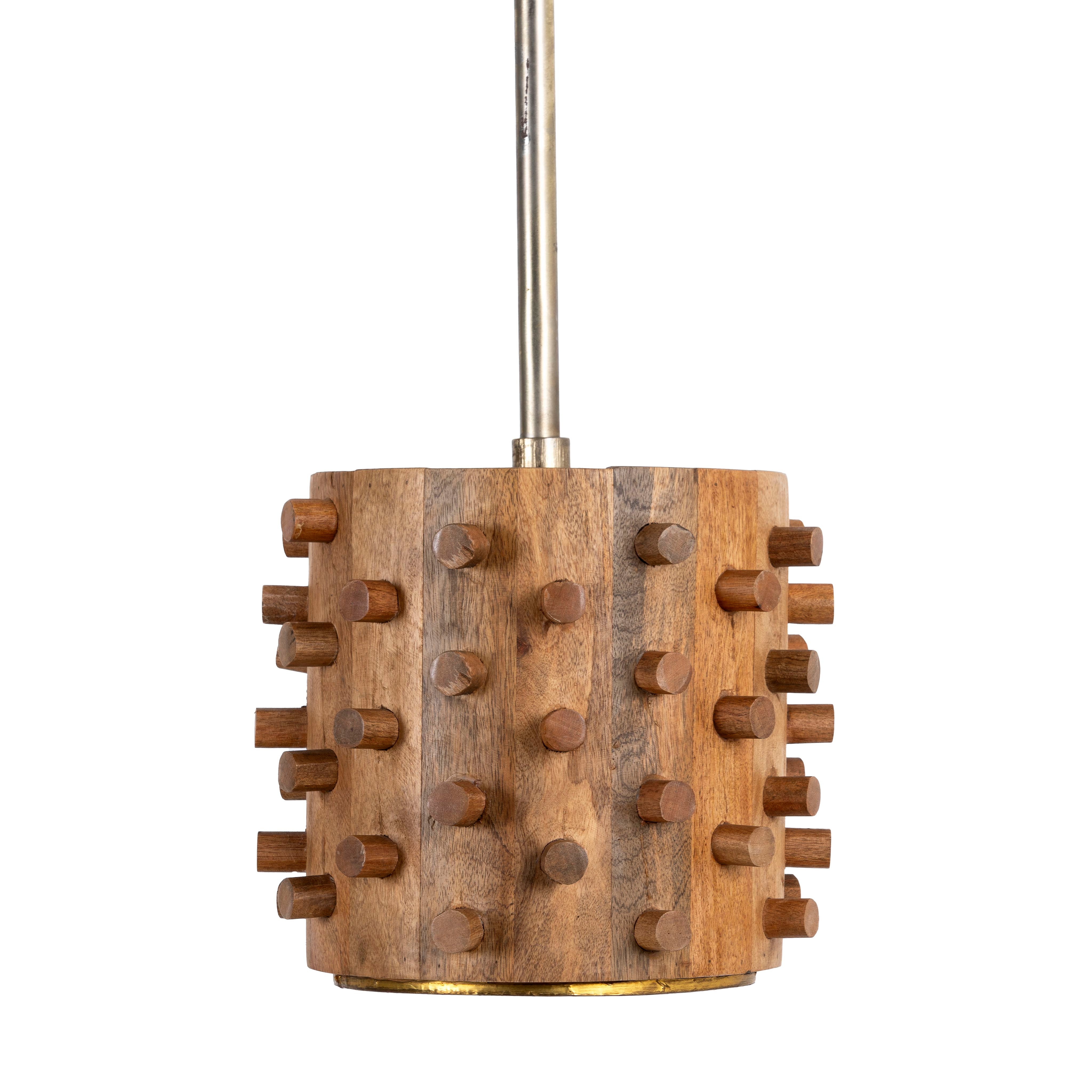 White background image of a wooden vintage pendant lamp made from carved mango wood with tree design and brass-plated hanging – a unique piece of mango wood lighting for dining rooms, living spaces, or entryways.
