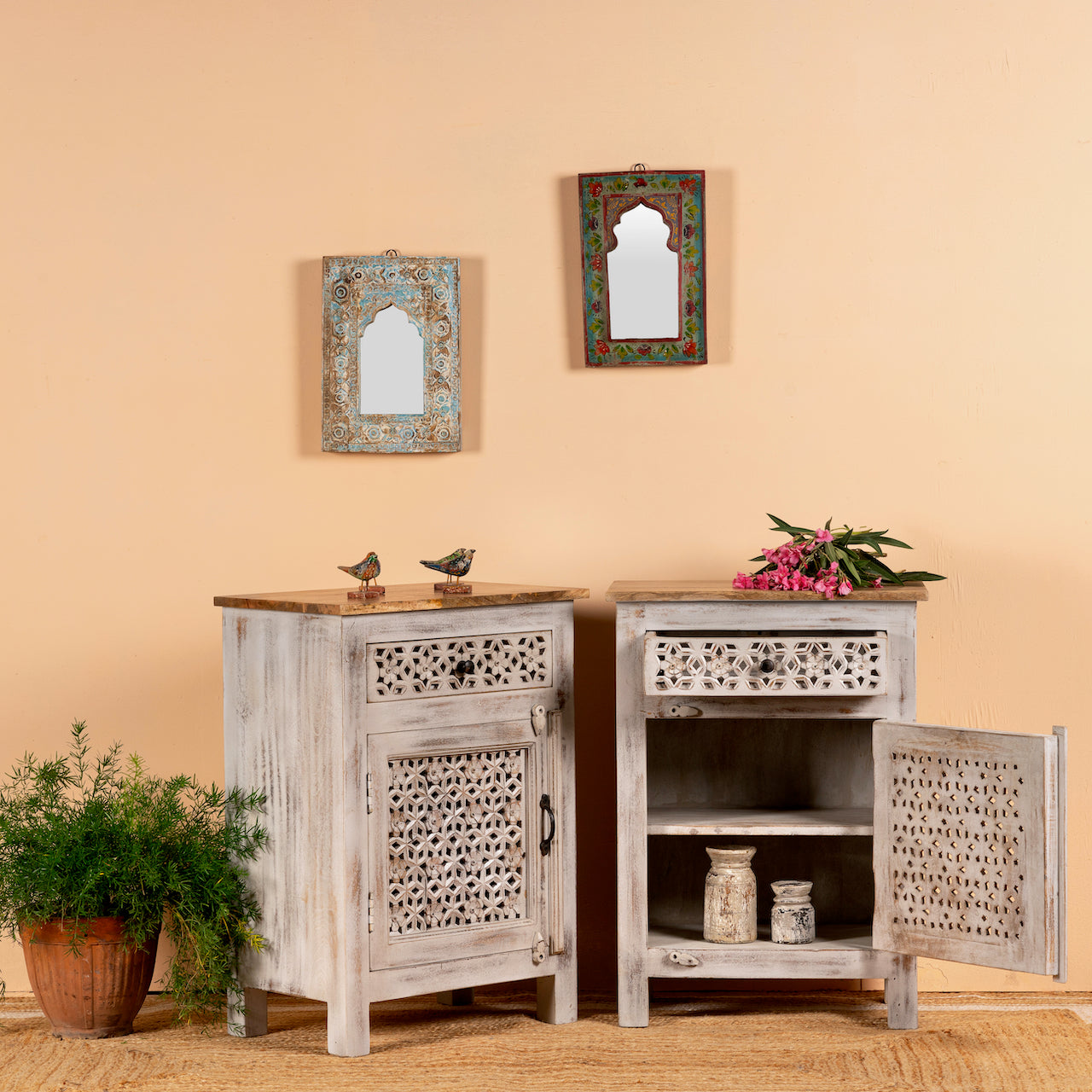 Open door image with a pair of carved nightstands made from mango wood with geometric patterns and distressed finish; perfect bedroom furniture, 76 × 56 × 35 cm.