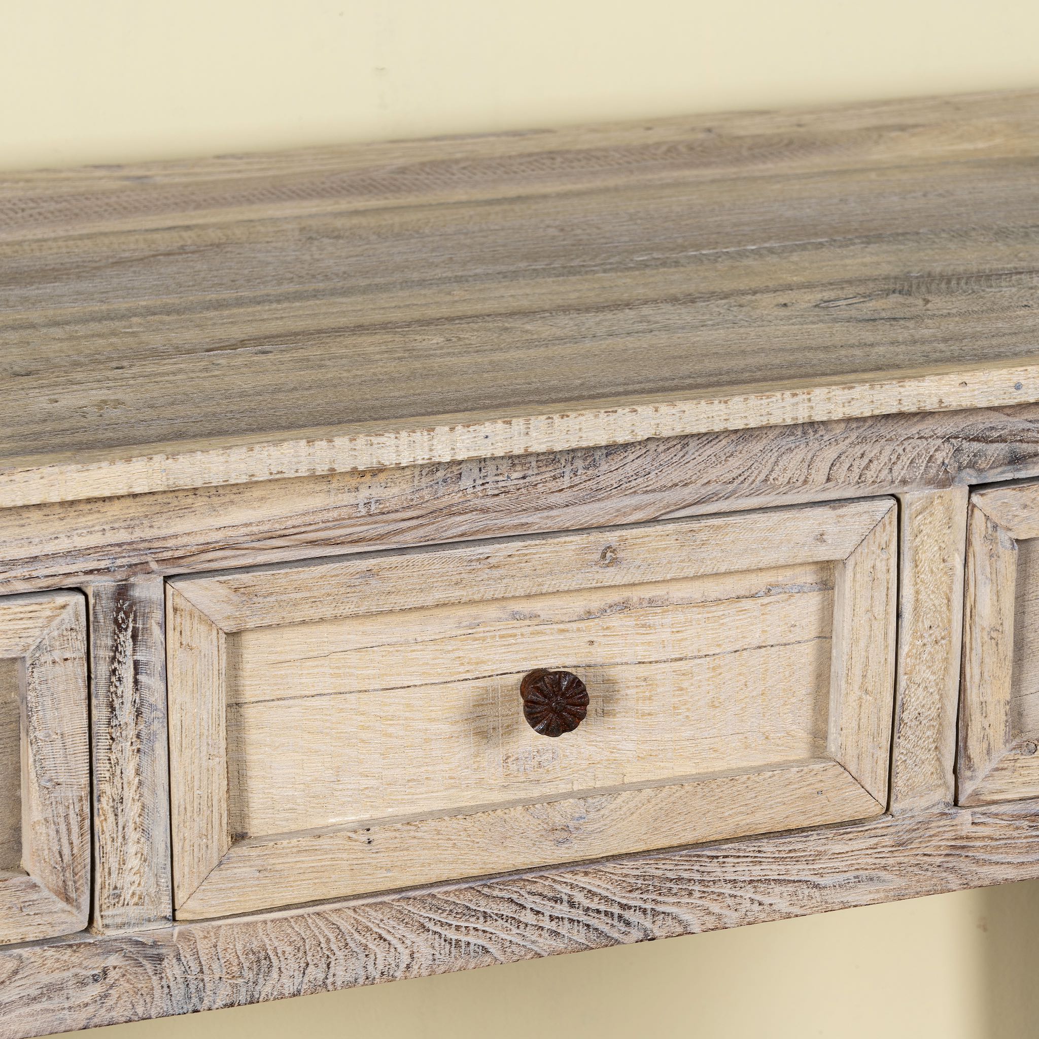 Close up image of a sandblasted reclaimed wood bathroom console table with 3 drawers and open shelf; sustainable furniture, 120 × 50 × 80 cm.