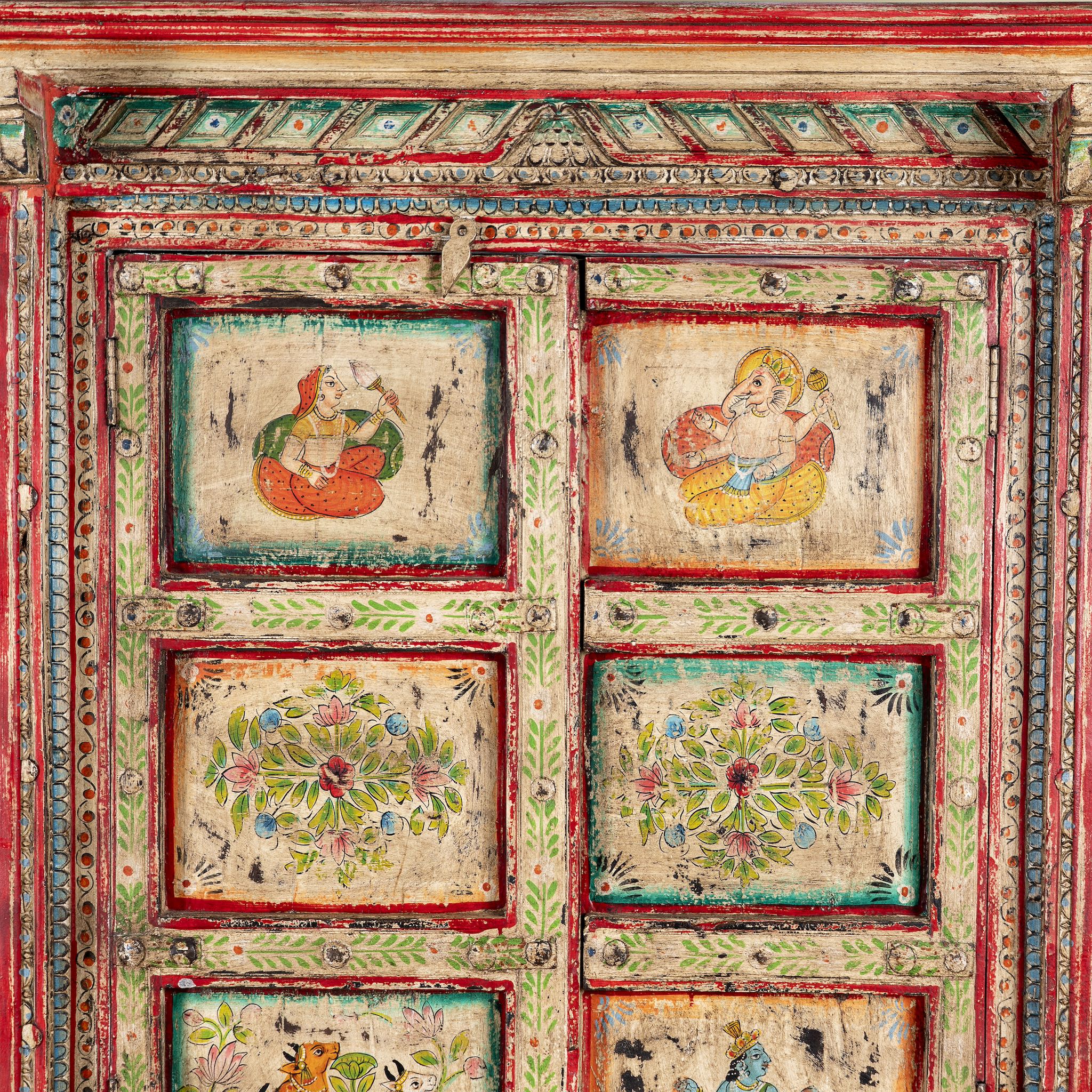 Close up image of a antique hand painted wardrobe made from reclaimed teak wood with Indian motifs; unique furniture and teak wood furniture, 113 × 50 × 190 cm.