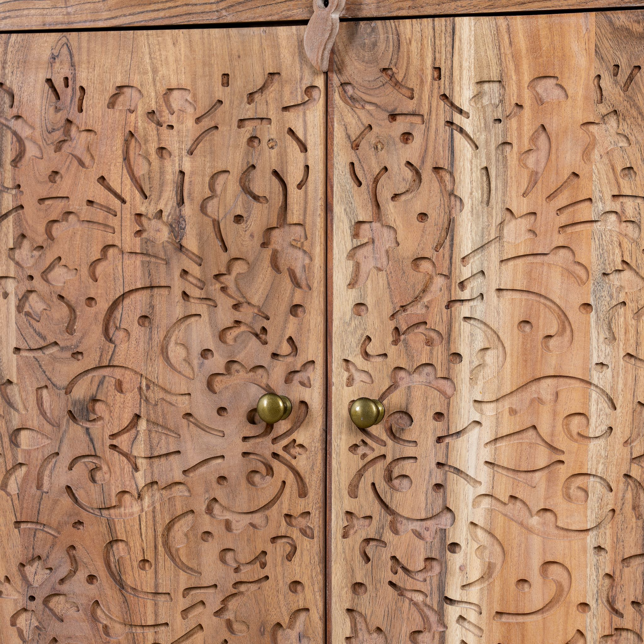 Close up picture of an acacia wood sideboard with floral carvings over all 4 doors and brass fitted door handles.