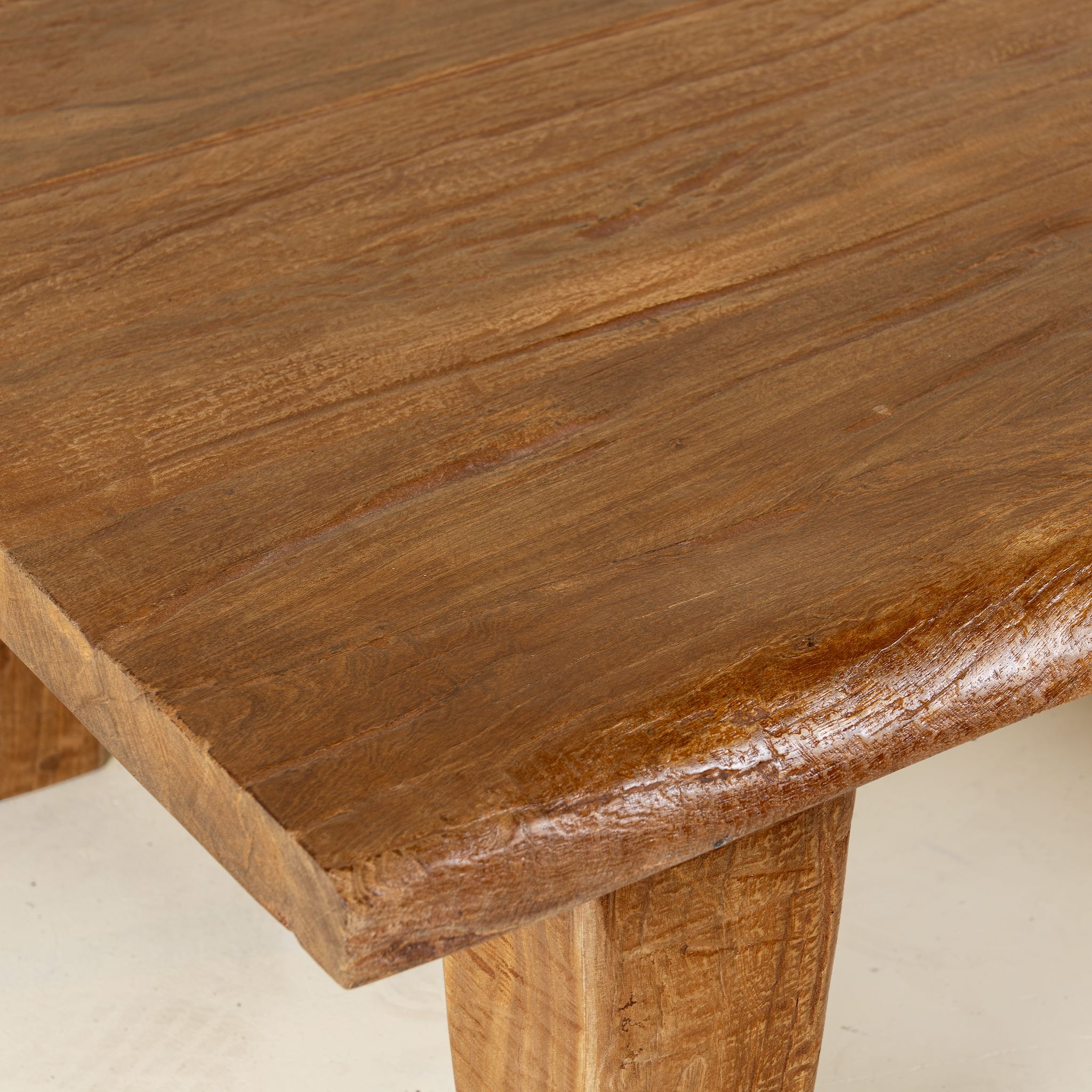 Close up picture of a handcrafted reclaimed wood coffee table with rounded edges and rustic grain; perfect for rustic interiors, 120 × 90 × 48 cm.