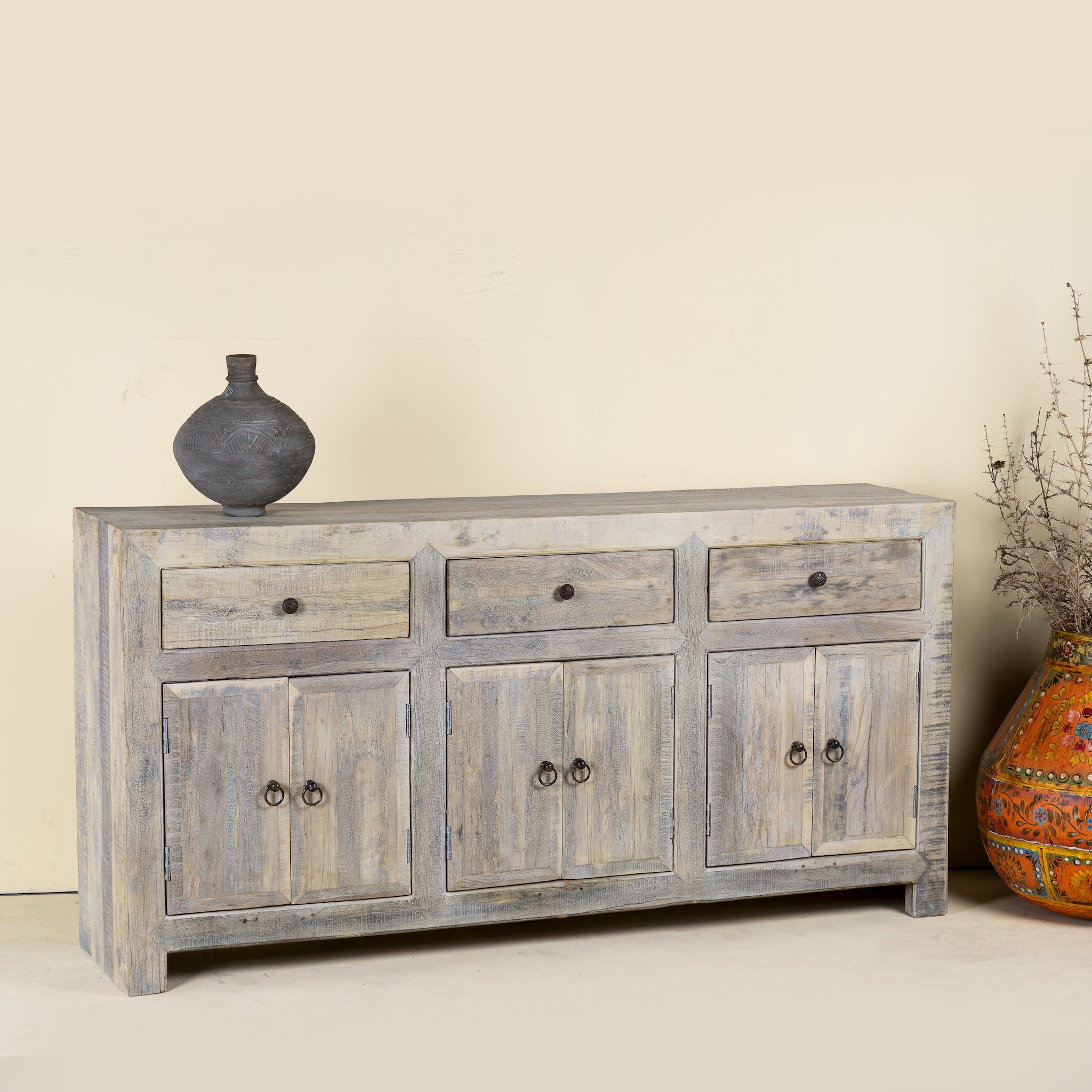 Side angle image of a sustainable bathroom sideboard made of reclaimed wood with four cupboards and three drawers, rustic finish, 180 × 40 × 90 cm.