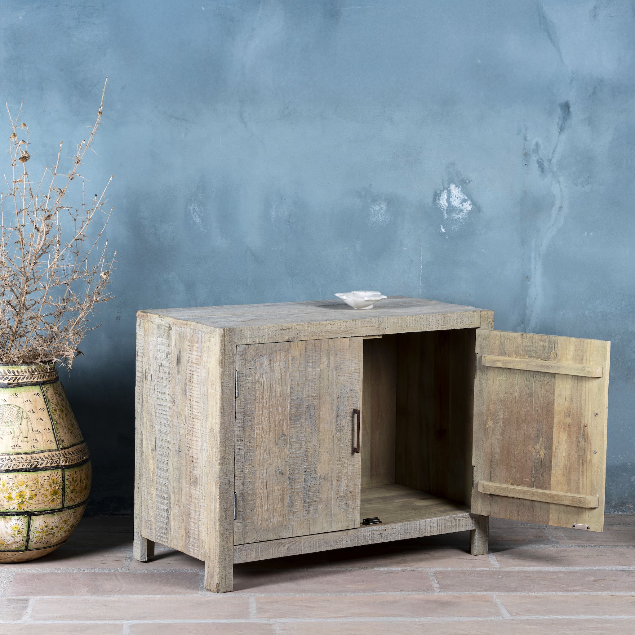 Side angle with an open door image of a Ibiza style bathroom cupboard made of reclaimed wood with sandblasted finish and two doors, 100 × 50 × 80 cm.