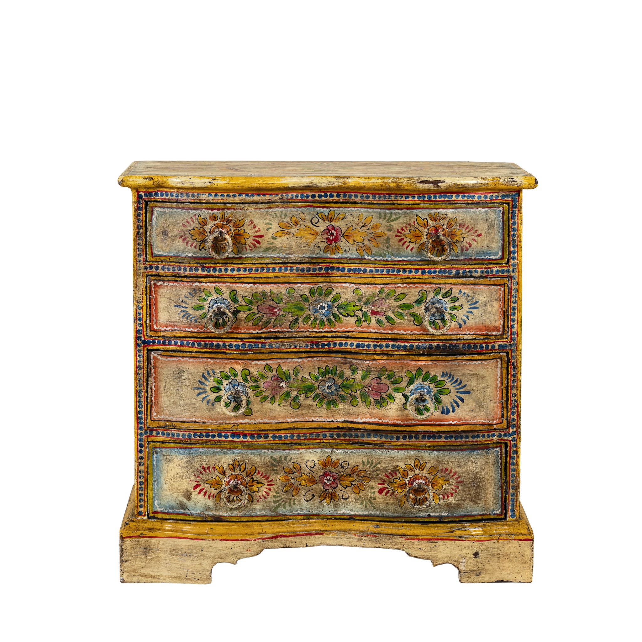 White background image of a hand-painted reclaimed wood chest of drawers with floral designs and distressed antique finish; perfect for bohemian interiors and vintage hand painted furniture lovers.