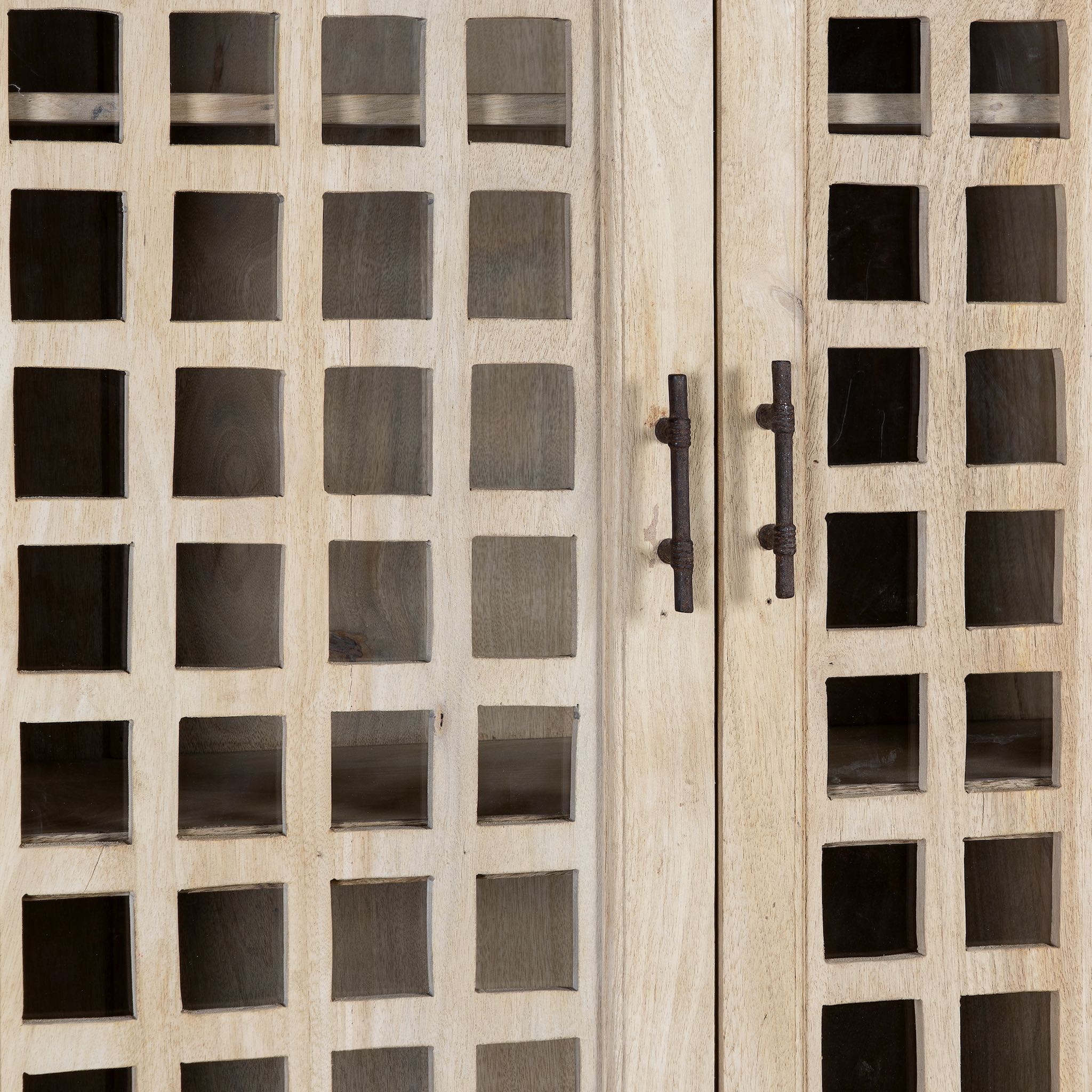 Close up image of a sandblasted mango wood showcase with two glass-panelled grid doors and four interior compartments, finished in a light sun-washed tone, ideal as living room furniture.