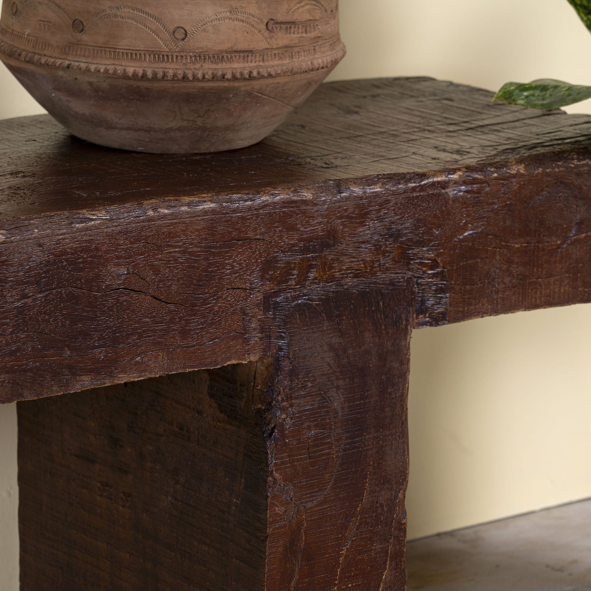 Close up image of a rustic wood bench made of reclaimed wood, full block design, sustainable furniture for hallways, living rooms, or terraces, 200 × 30 × 40 cm.