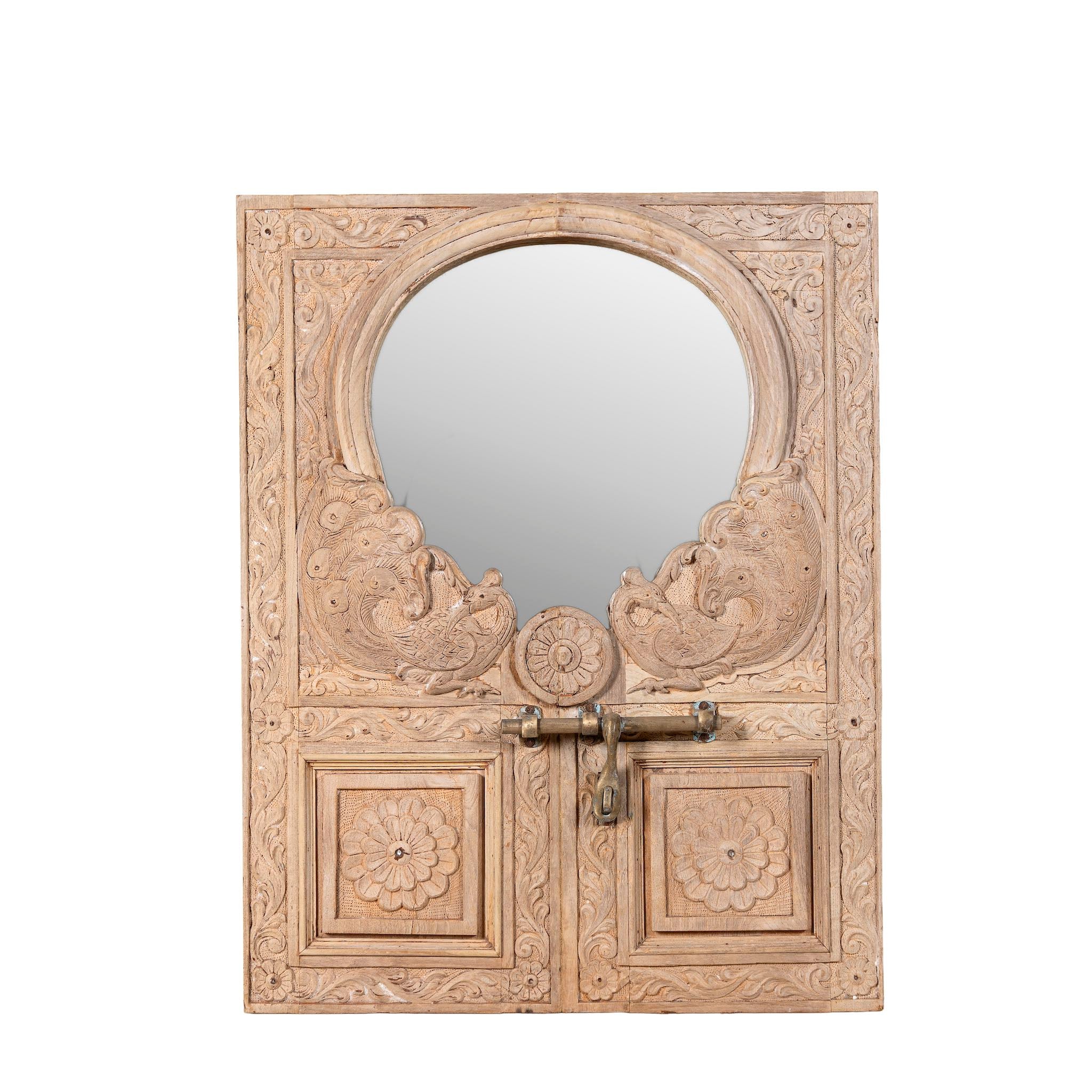 White background image of a handcarved teak wood mirror made from an antique Indian window frame with brass lock; unique wooden furniture, 60 × 70 cm.