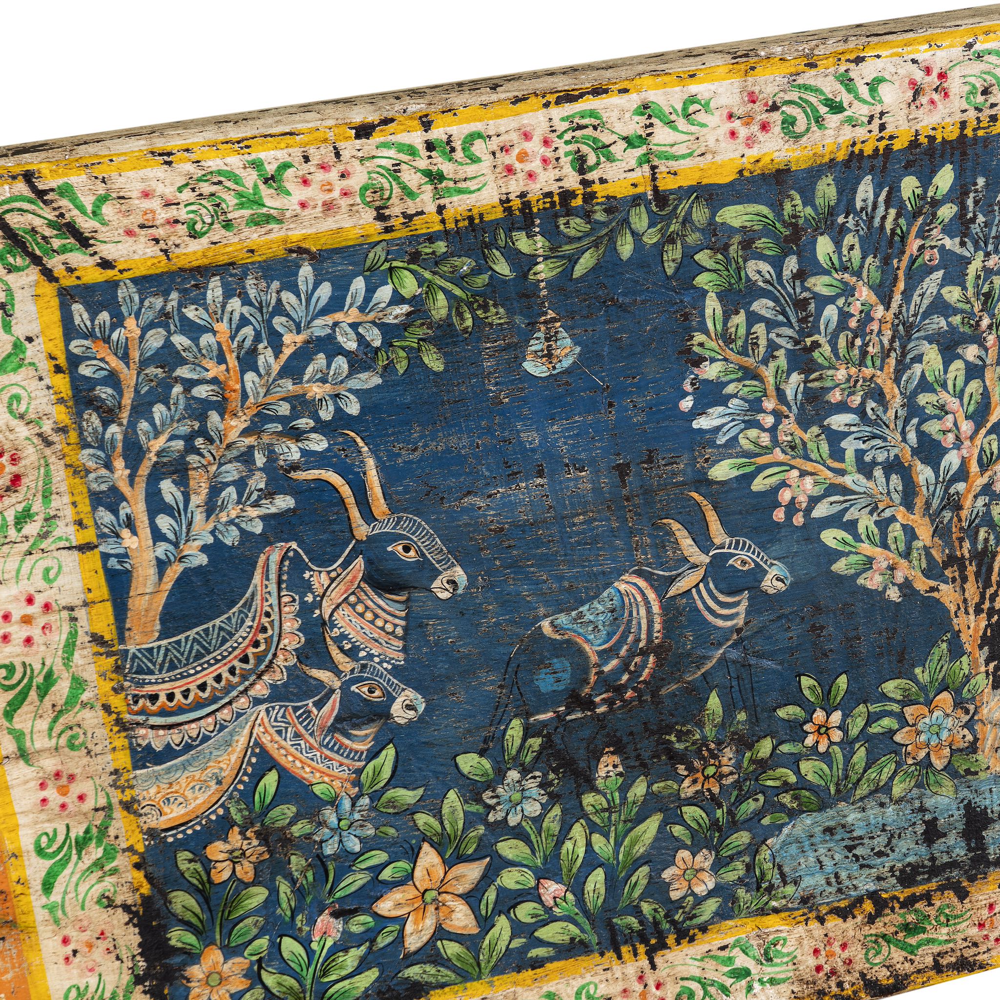 Close up image of a hand-painted Indian wall panel made from reclaimed teak wood door with royal and animal motifs; unique wall panel in boho style décor, 208 × 4 × 55 cm.