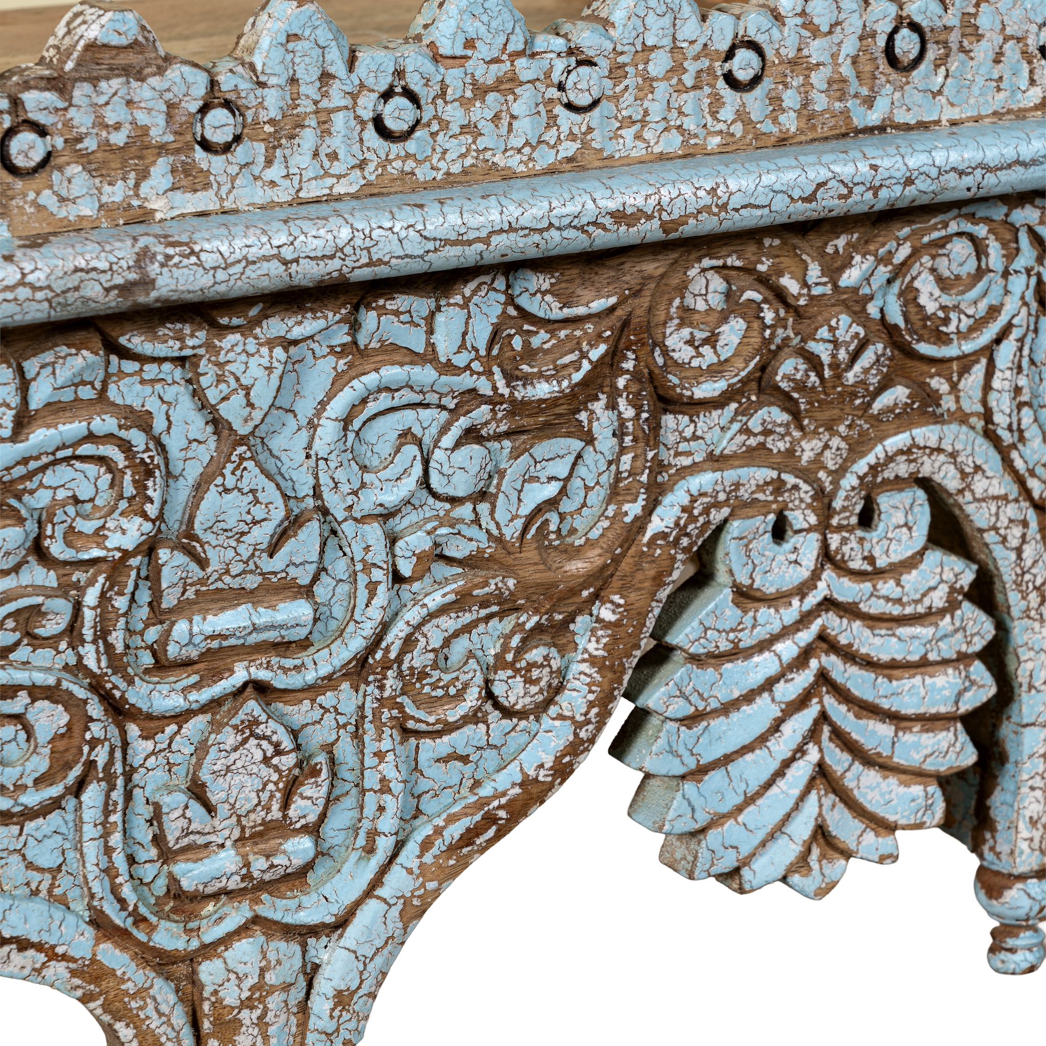Close up image of a turquoise distressed mango wood shelf with ornate carvings; artisanal furniture and vintage home decor, 60 × 32 × 32 cm.