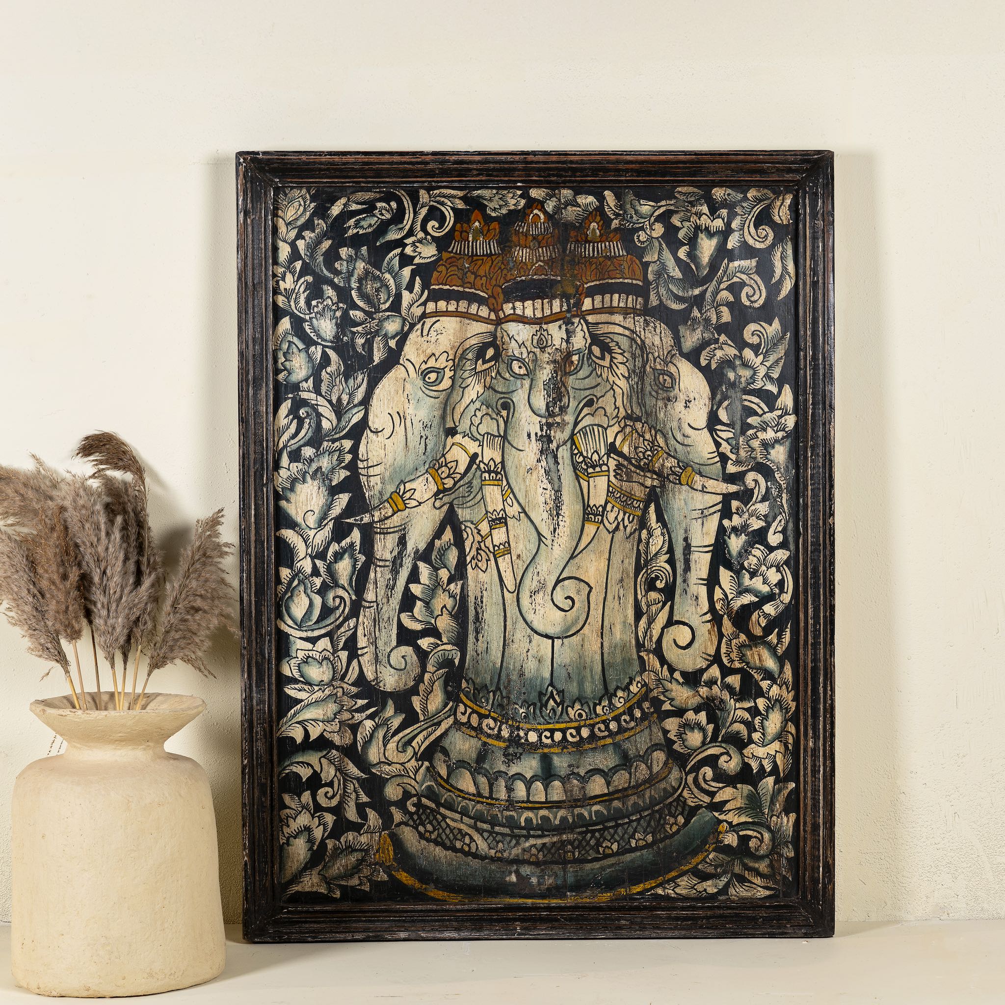 Hand-painted wall panel made from old teak wood, featuring an intricate depiction of Lord Ganesh in vibrant earthy tones, surrounded by ornate floral patterns, showcasing traditional Indian artistry and spiritual symbolism.