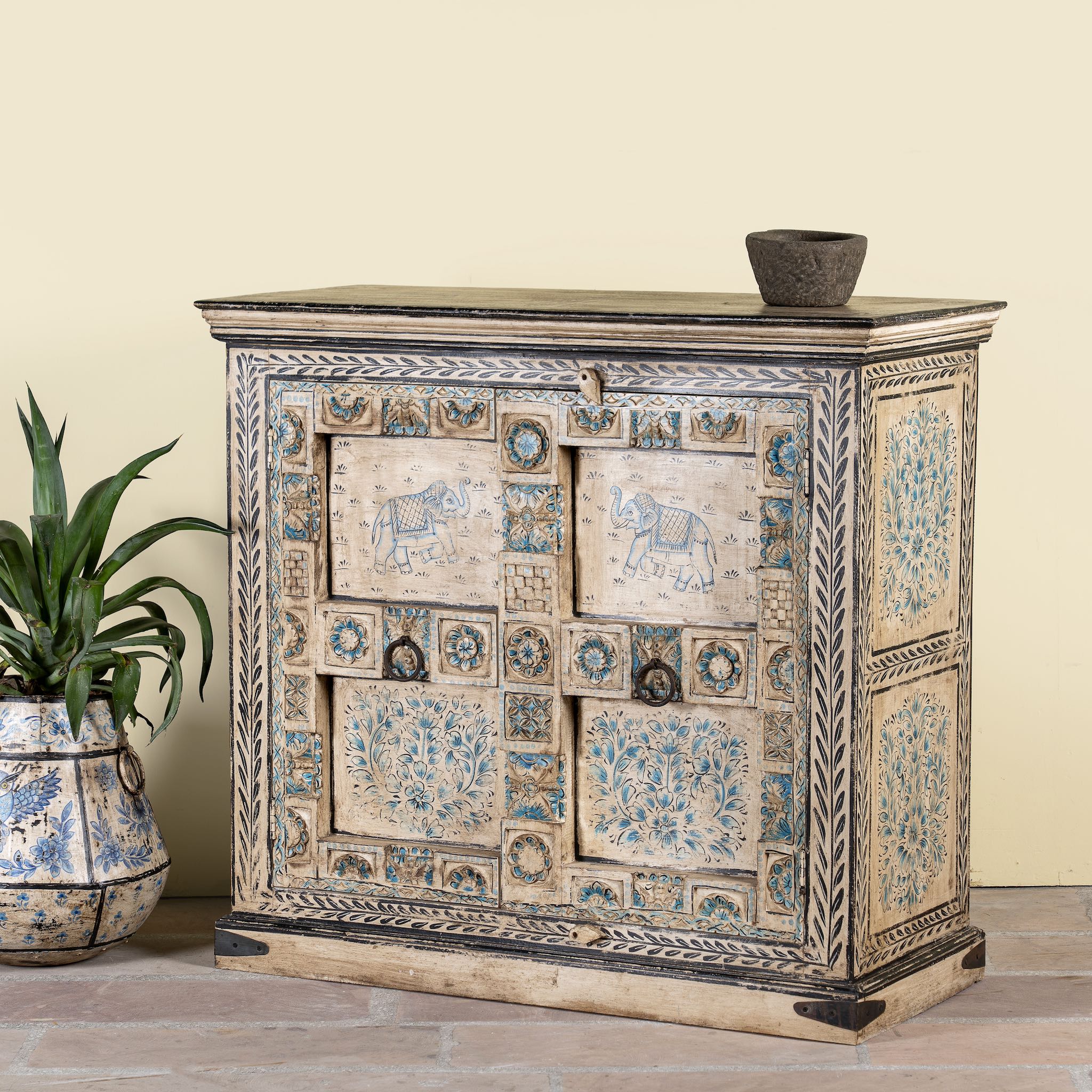 Side angle image of a hand-painted cupboard made from reclaimed wood and old Indian doors – a sustainable furniture piece perfect for Indian home decor and rustic interiors.