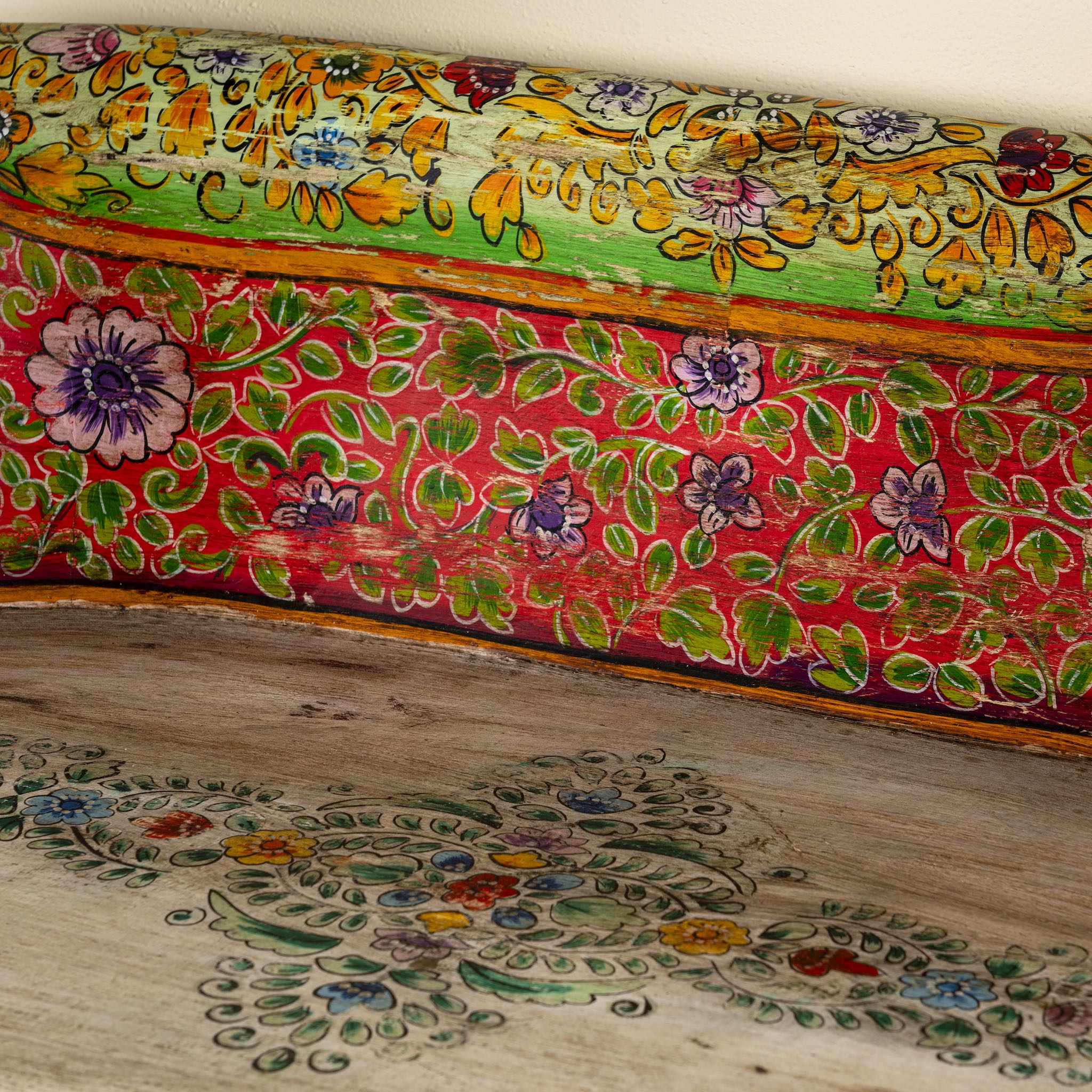 Close up image of a hand-painted reclaimed wood chair-style horse bench with double carvings; unique furniture for a bohemian interior, 160 × 70 × 90 cm.