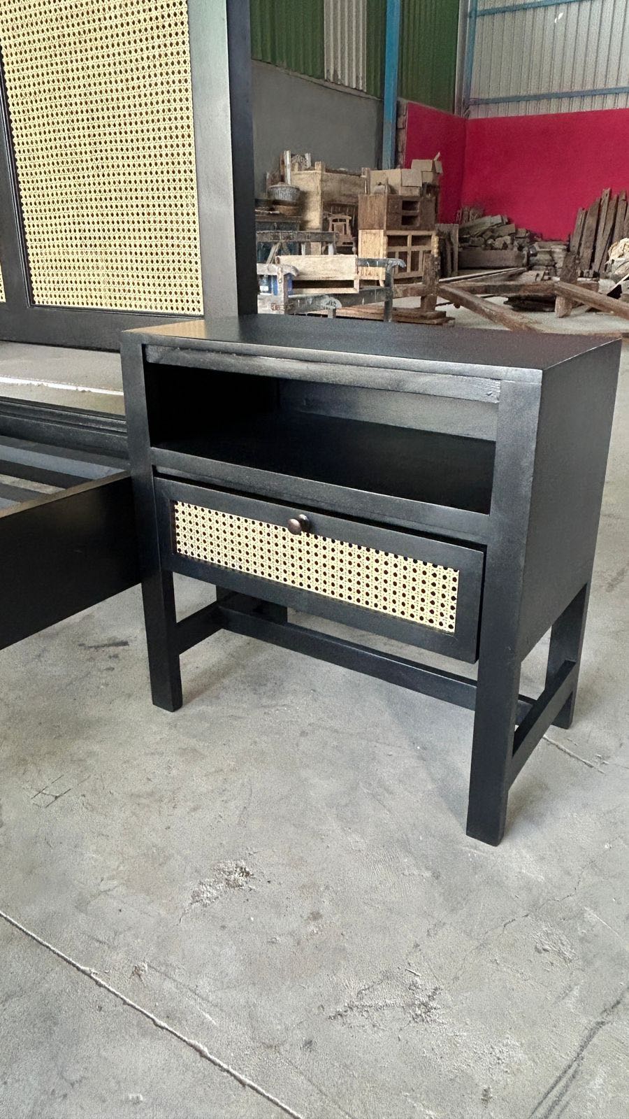 Side angle image of a mango wood night stand with rattan inserts; artisanal rattan furniture, 60 × 35 × 60 cm.