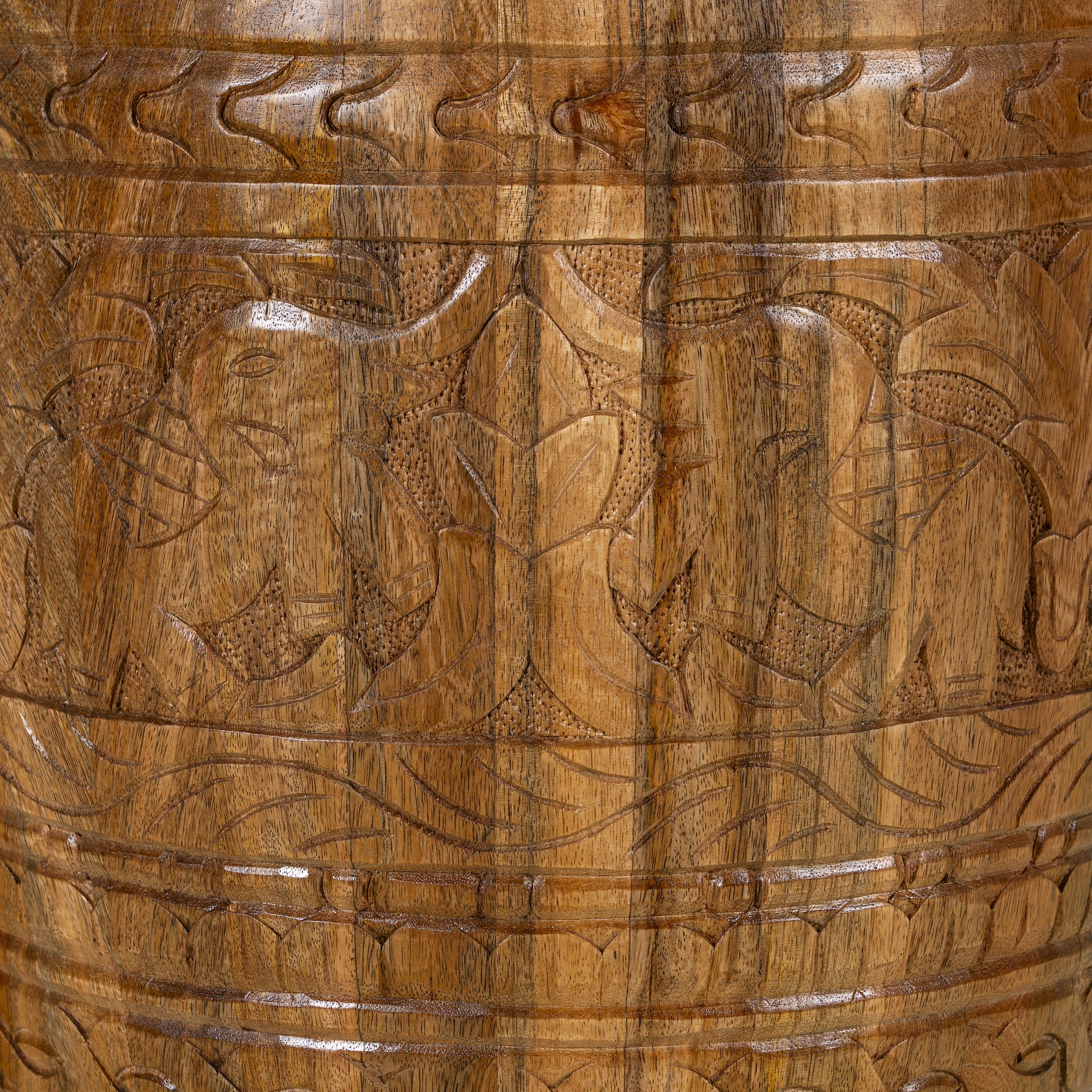 Close up image of a hand-carved mango wood coffee table with barrel shape and warm rustic finish; vintage style coffee table, 45 cm diameter, 55 cm height.