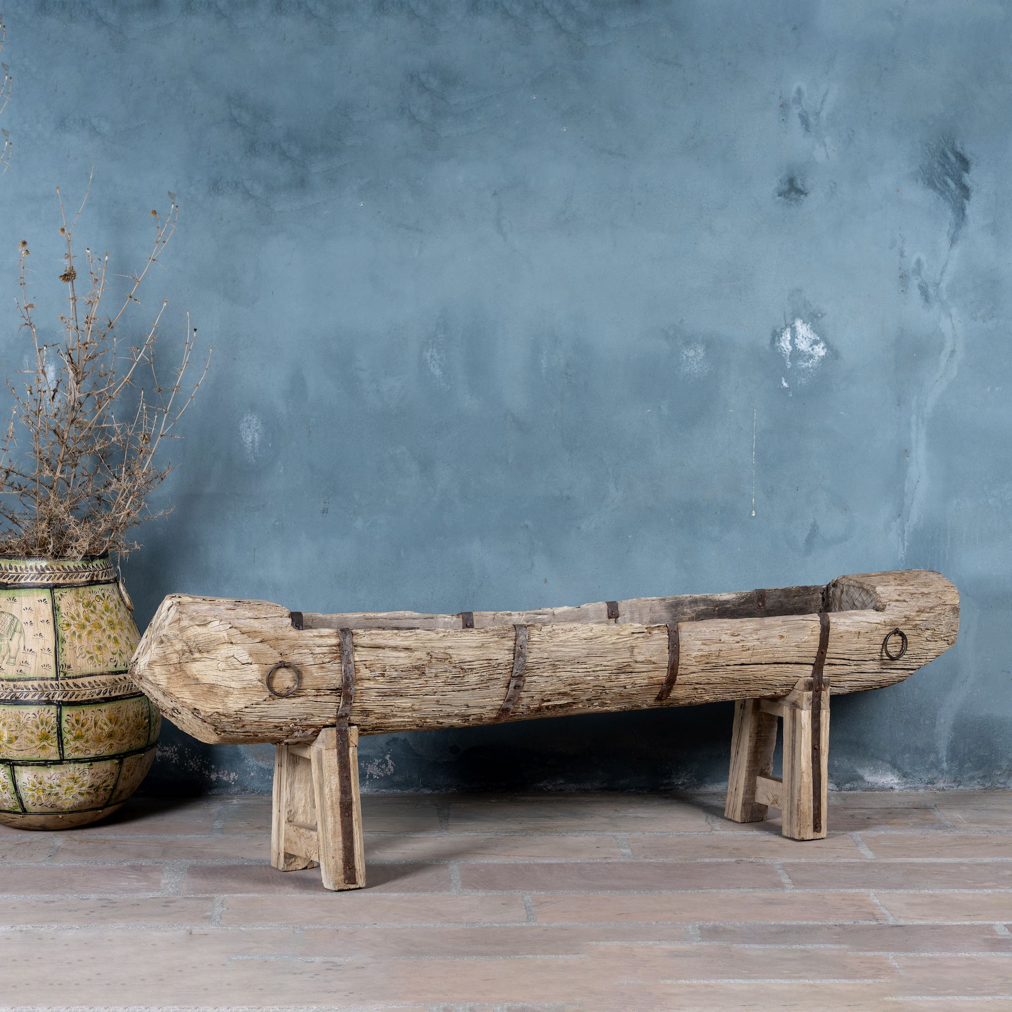 Antique console table repurposed from reclaimed teak wood feeding trough with carved details and iron fittings; unique furniture ideal for rustic interiors, compatible with teak wood benches, 234 × 31 × 61 cm.