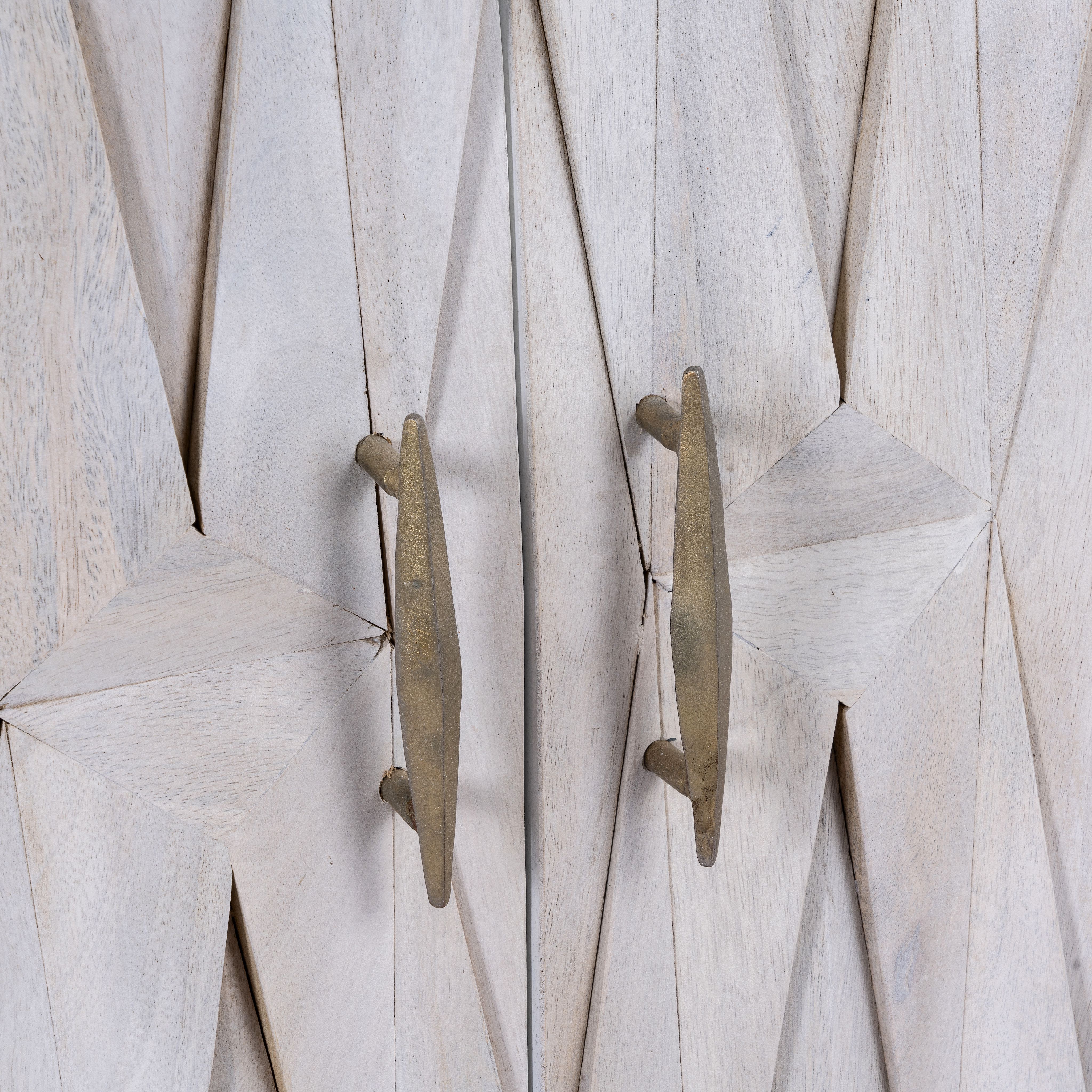 Close up image of a whitewashed mango wood sideboard with raised criss-cross design, four doors, and silver metal legs—elegant living room furniture with modern rustic appeal.