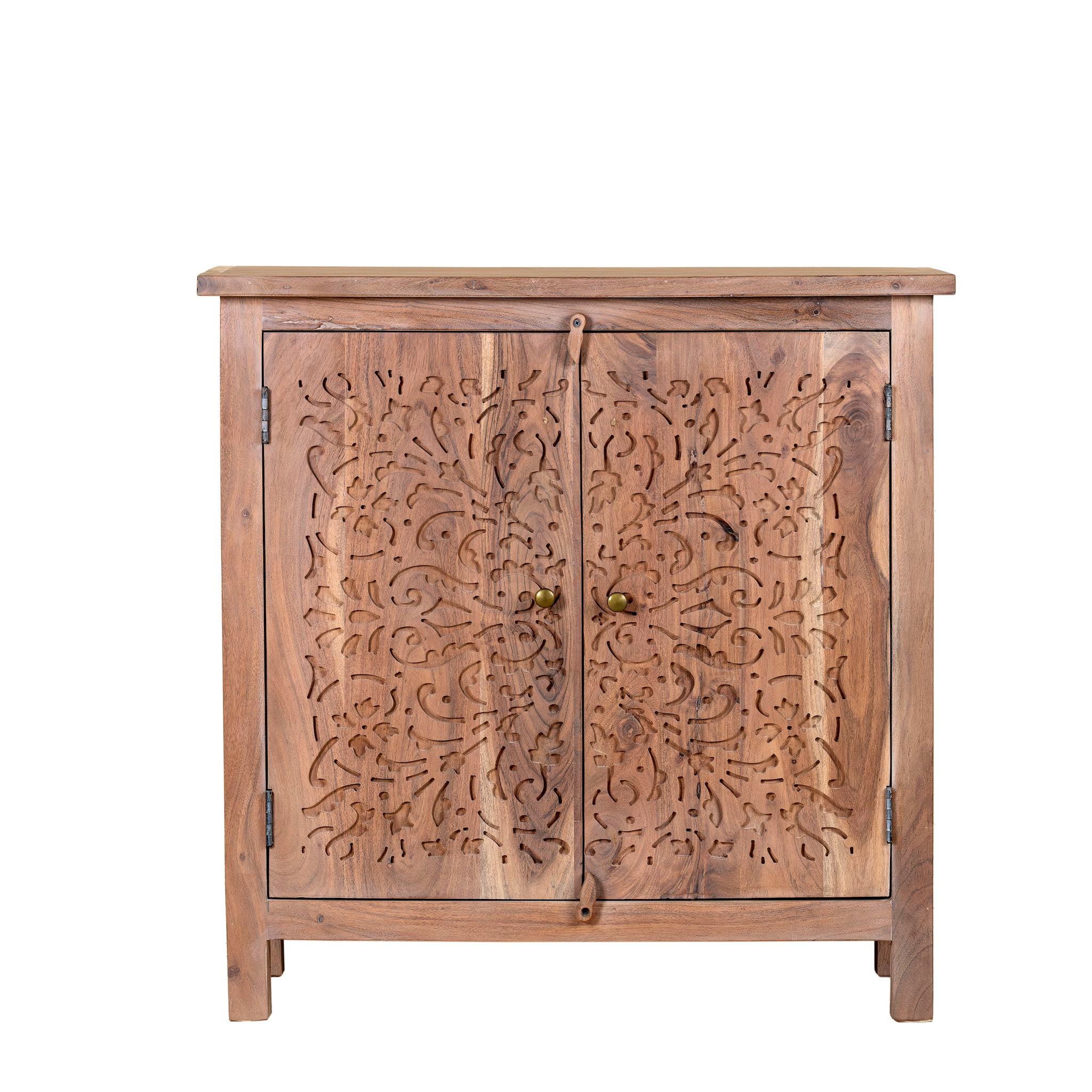 White background image of a carved acacia wood cupboard with floral cutout doors and brass knobs, 90 × 40 × 90 cm.