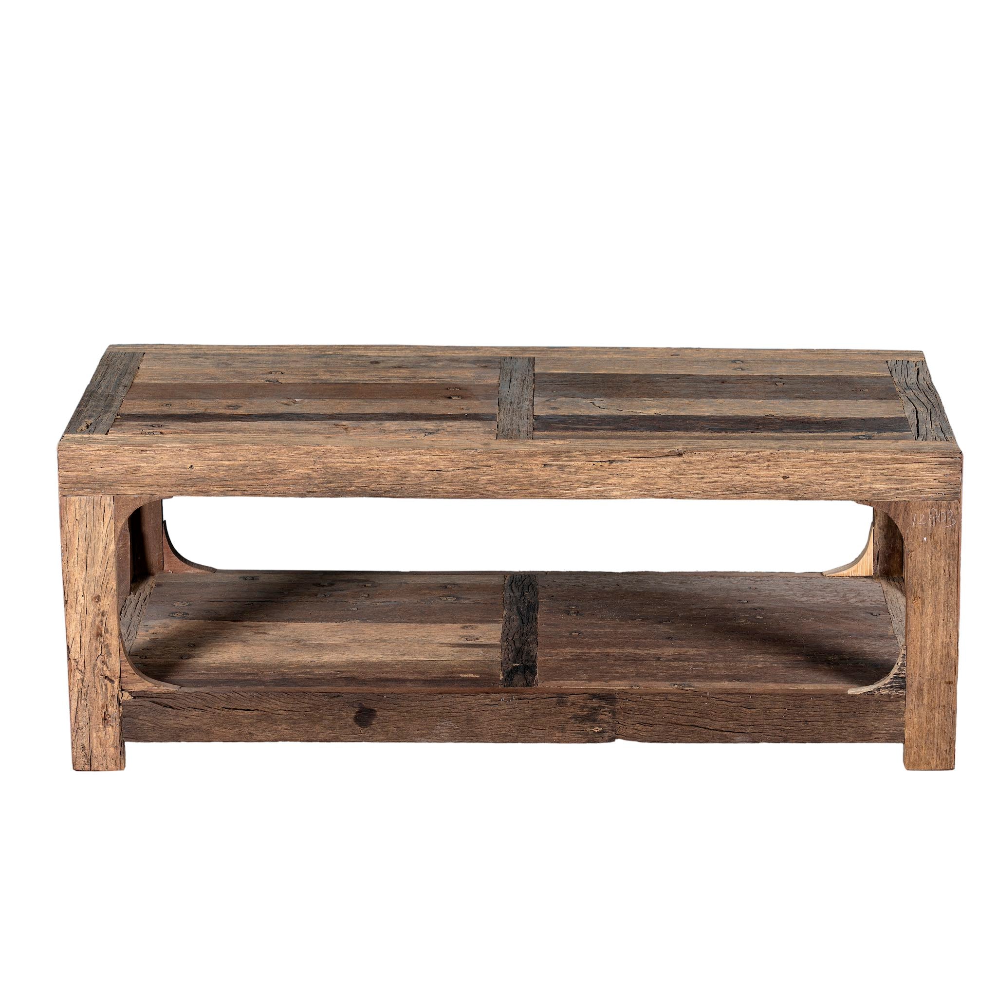 White background view of a driftwood coffee table made from reclaimed wood with rustic finish and open lower shelf; sustainable furniture, 120 × 60 × 40 cm.