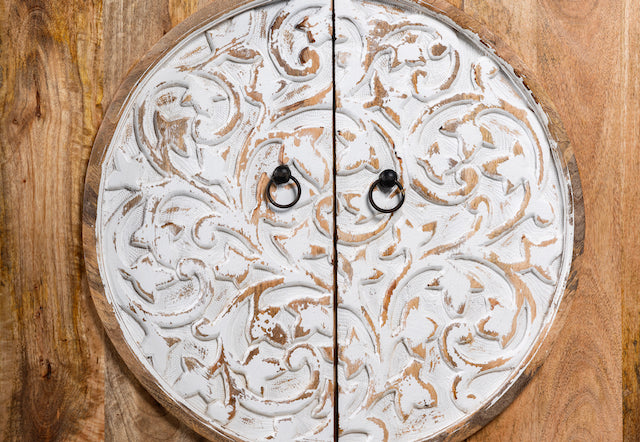 Close up image of a carved wood furniture cabinet made from mango wood with floral detailing and whitewashed finish, 90 × 90 × 40 cm.