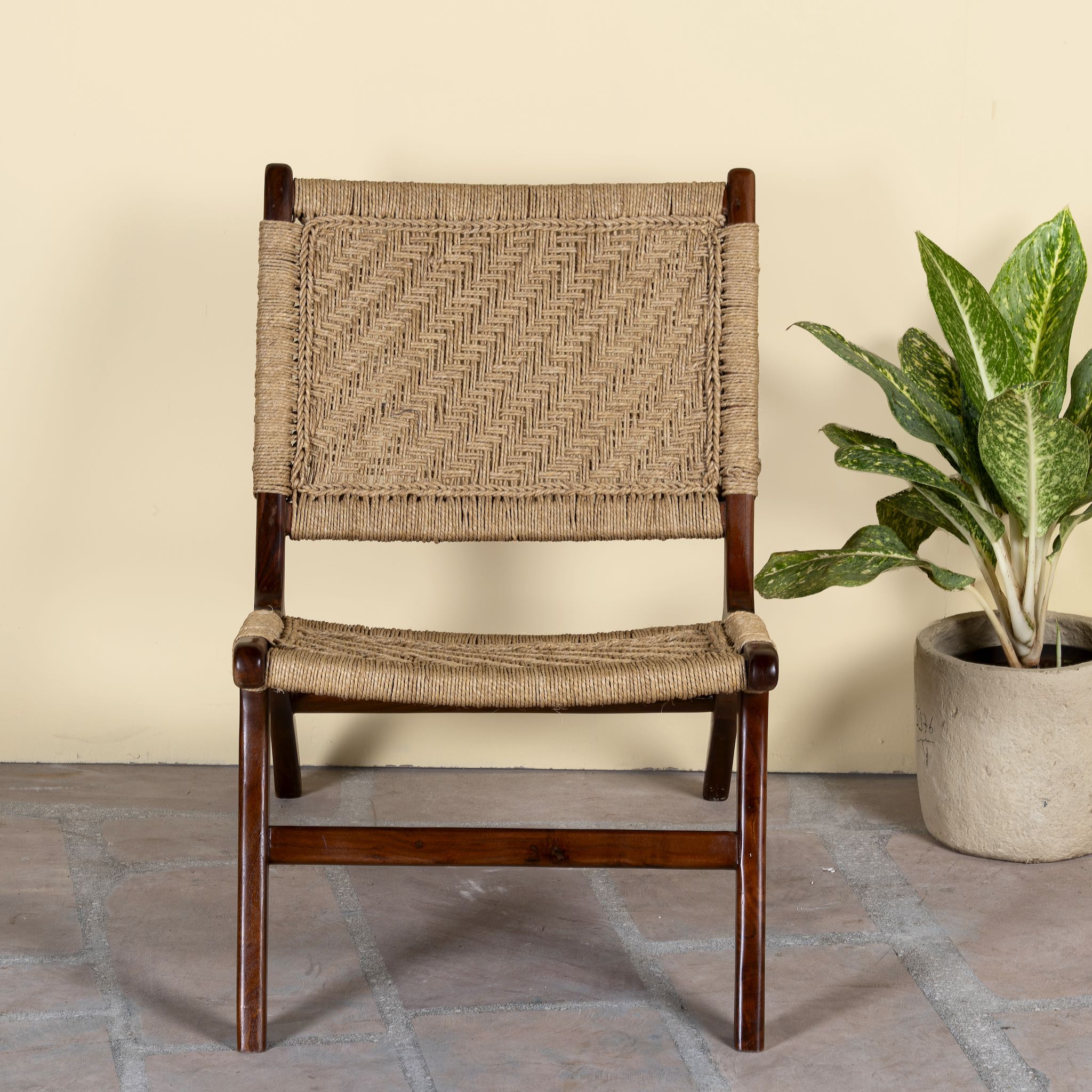 Acacia wood chair with handwoven cotton rope seat and backrest; rustic wooden armchair for living rooms or lounges, 60 × 80 × 95 cm.