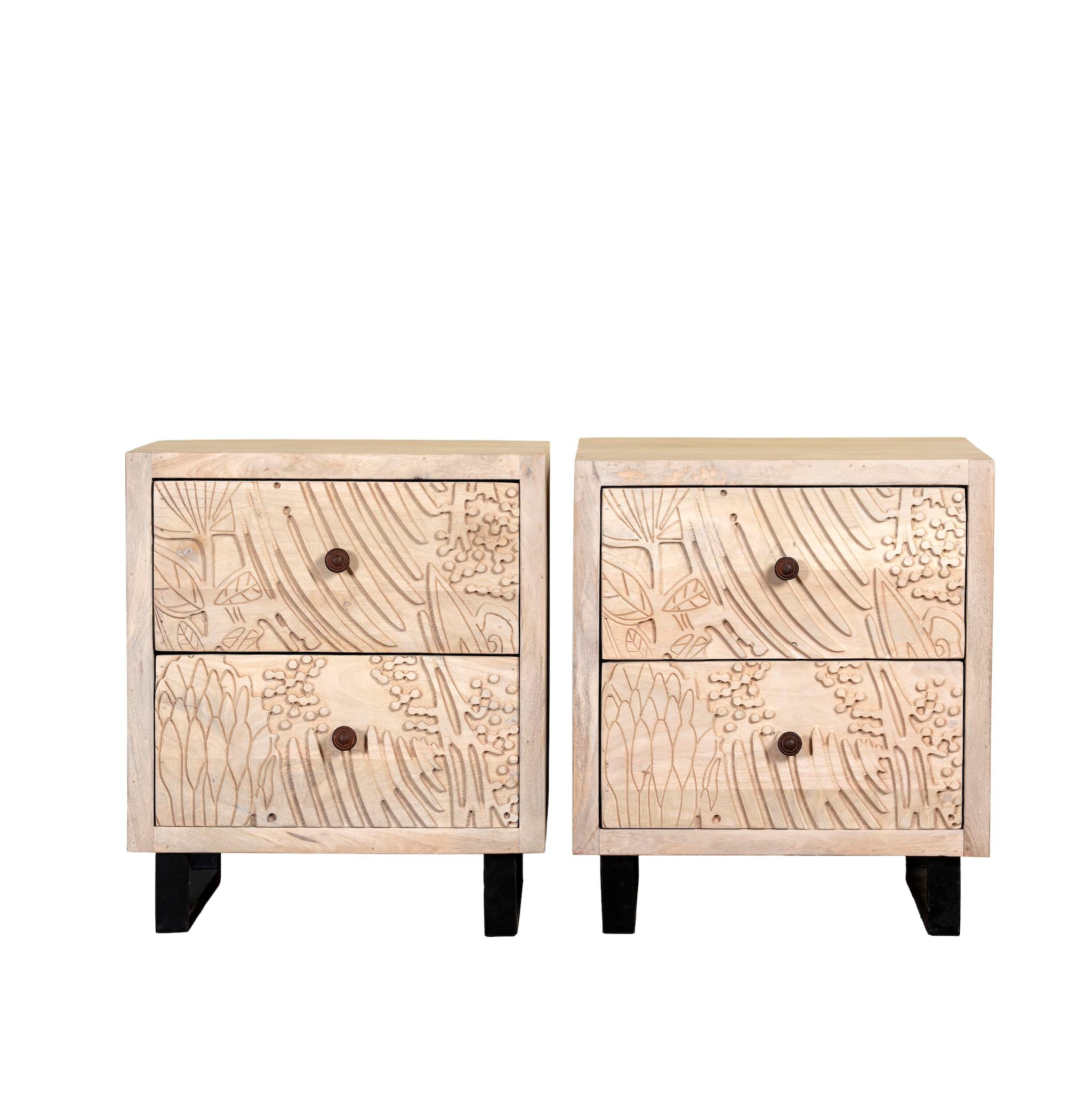 White background image of a pair of mango wood nightstands with hand-carved sandblasted finish and black iron stand; artisanal bedroom furniture, 51 × 41 × 59 cm.