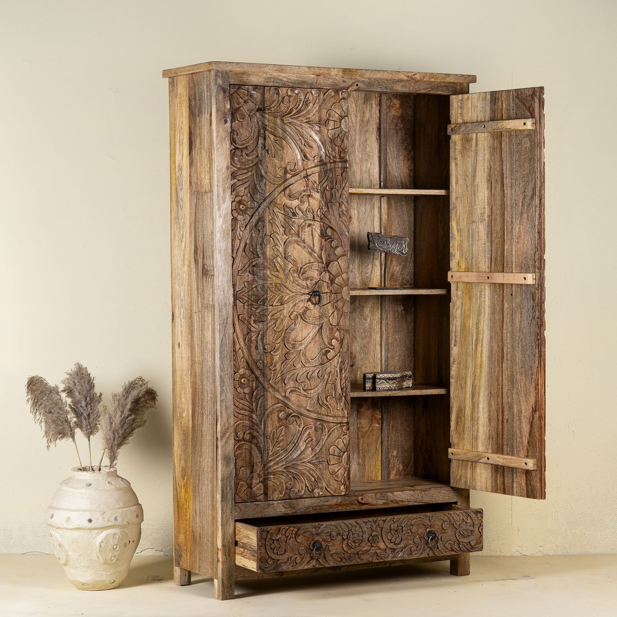 Wooden wardrobe with intricate carvings on a beige background
