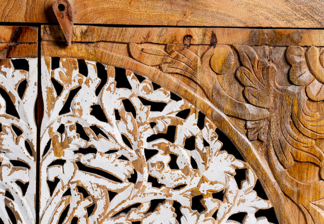 Close up image of a hand-carved mango wood sideboard with Tree of Life motif, whitewashed finish, and four storage compartments; artisanal mango wood furniture for dining rooms, entryways, or living areas, 180 × 90 × 40 cm.