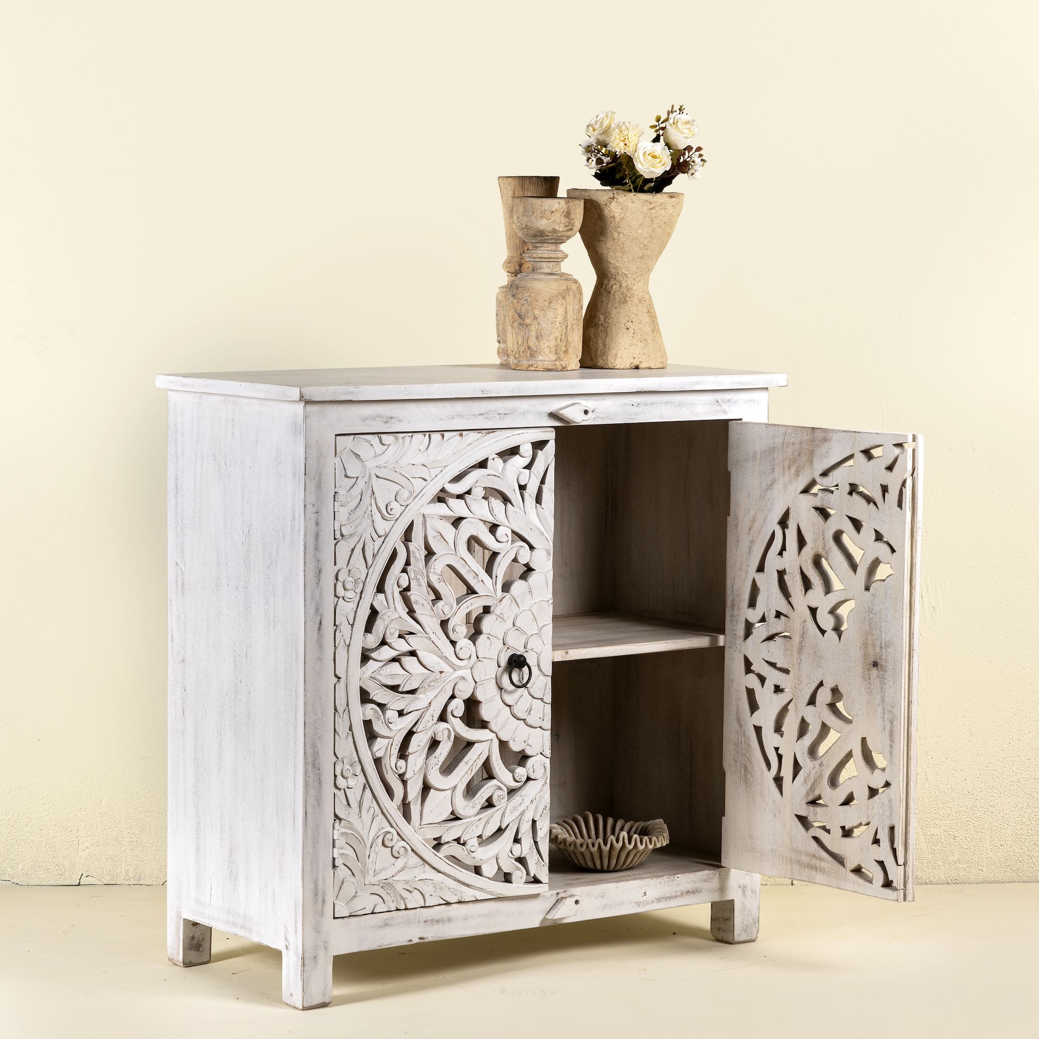 Open door image of a white carved wood cabinet made from solid mango wood with hand-carved Indian motifs, 90 × 90 × 40 cm.