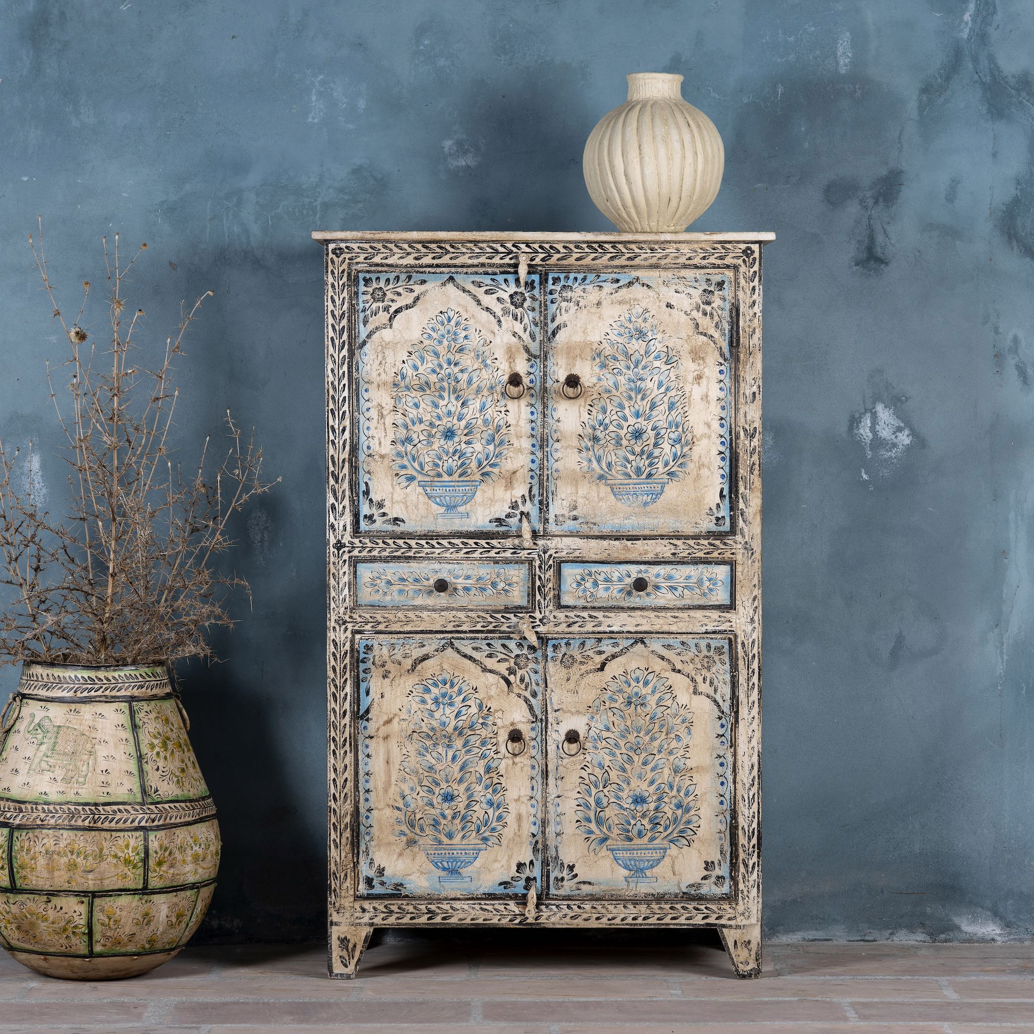 Hand-painted wooden cabinet made from reclaimed wood with blue floral motifs – sustainable furniture with artistic charm and vintage appeal.