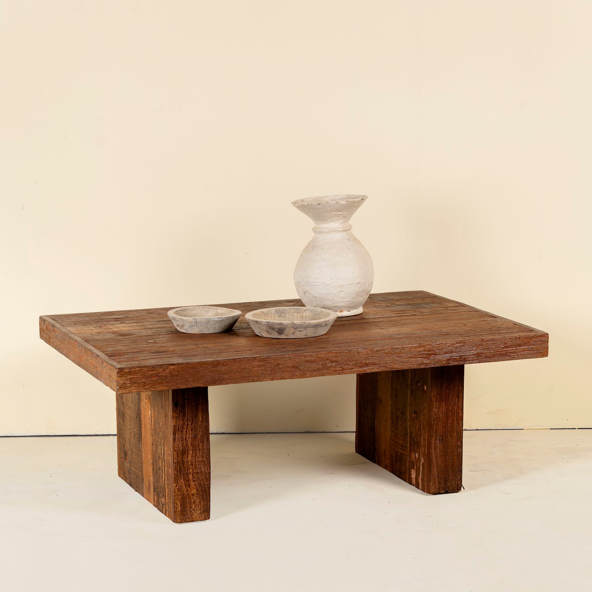 Rectangular reclaimed wood coffee table with block legs; sustainable furniture for rustic and modern interiors, 120 × 80 × 46 cm.