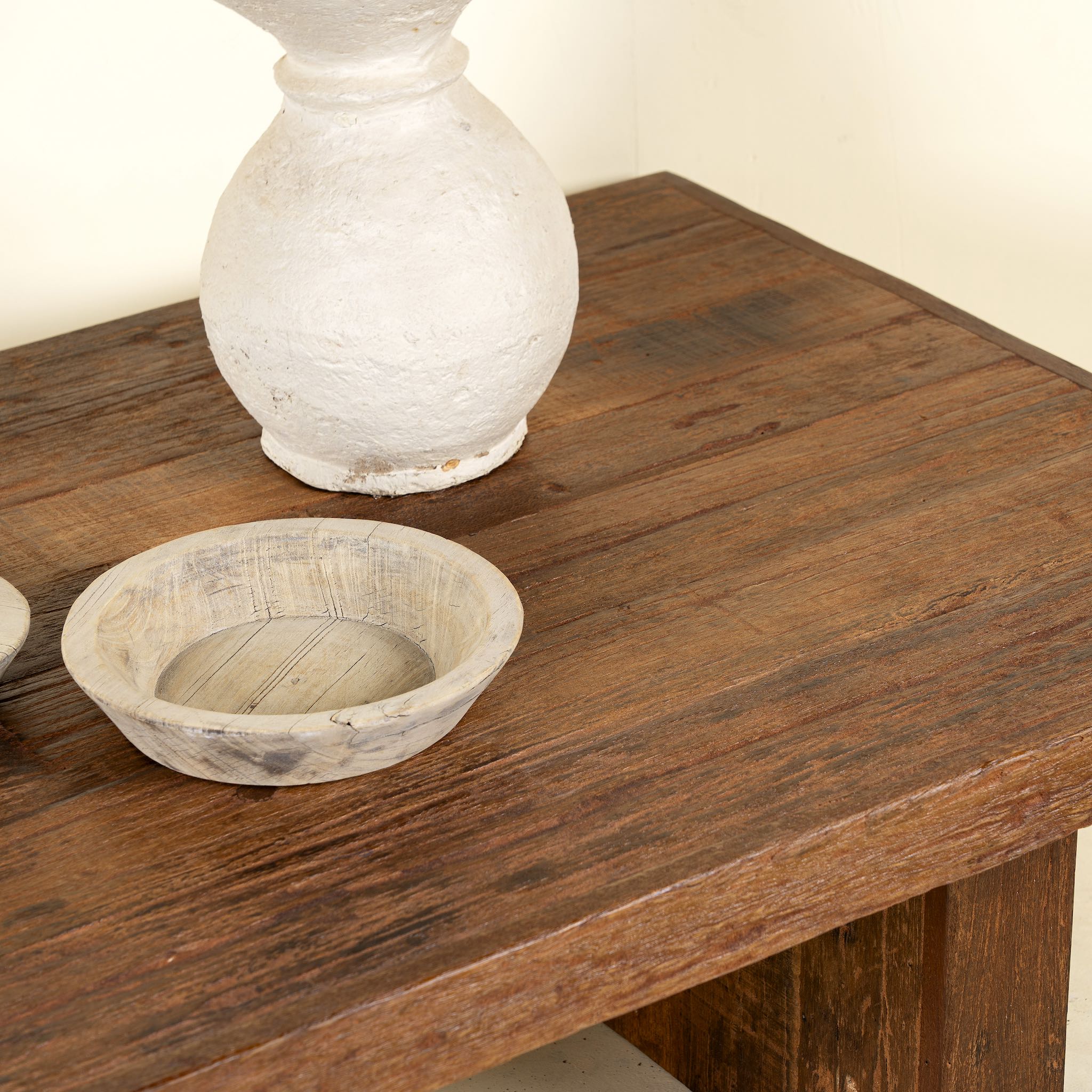 Close up picture of a rectangular reclaimed wood coffee table with block legs; sustainable furniture for rustic and modern interiors, 120 × 80 × 46 cm.
