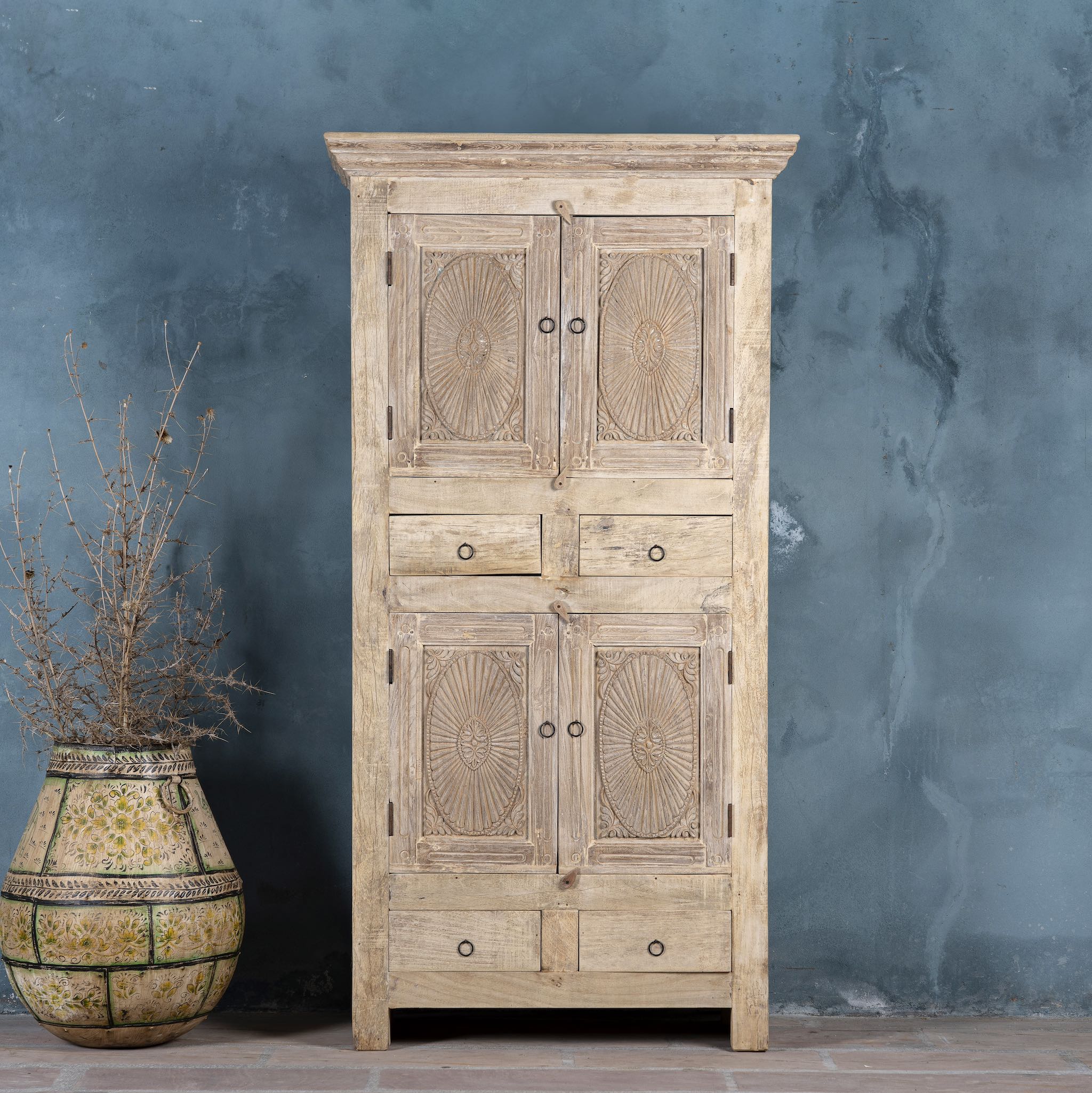 Wardrobe made from reclaimed wood with a sandblasted finish, featuring four carved doors, six drawers, and a light, rustic look in timeless Ibiza style.