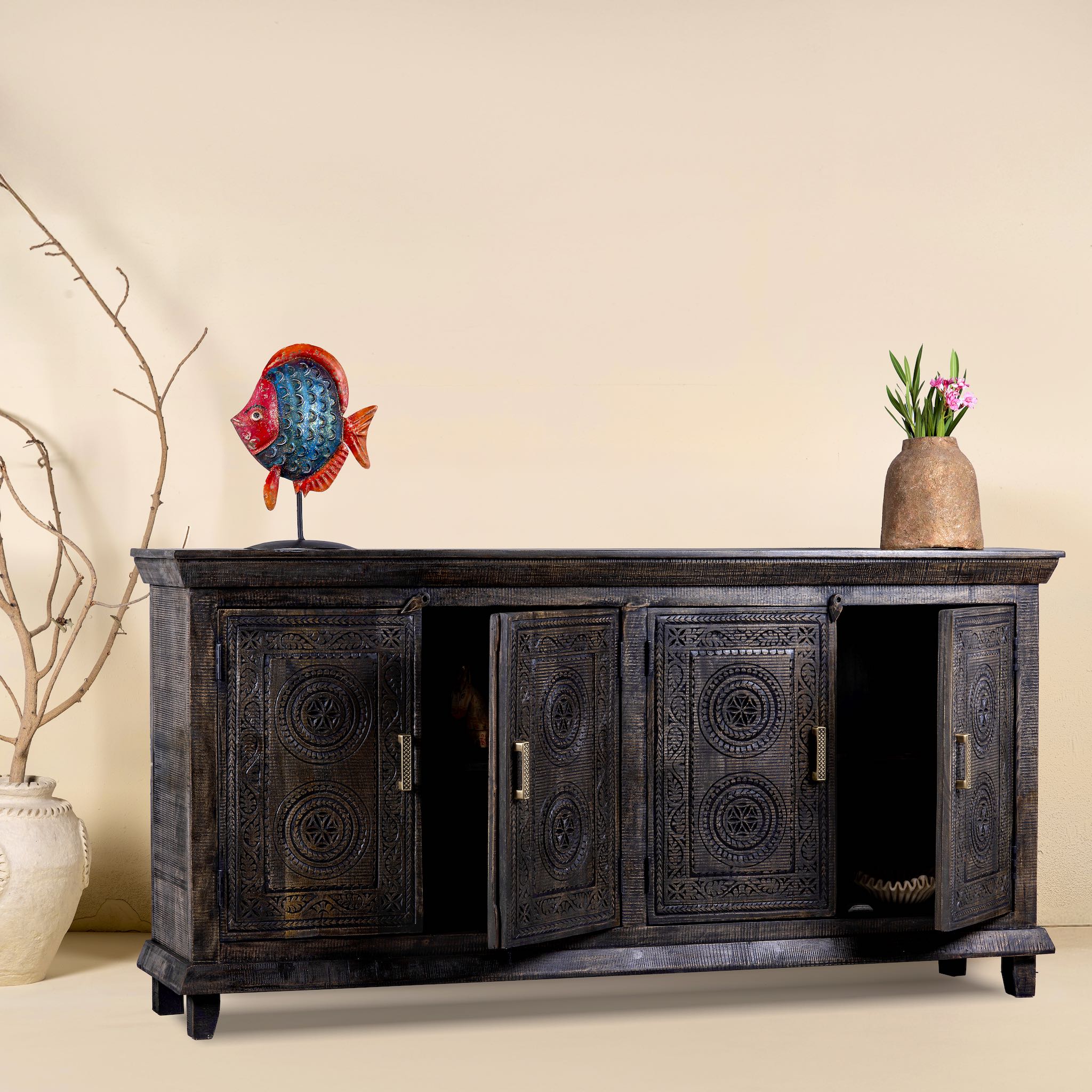 Side angle image with open doors of a handcrafted wood carved sideboard in black mango wood with four doors, versatile for bedroom furniture or living spaces, 180 × 40 × 90 cm.