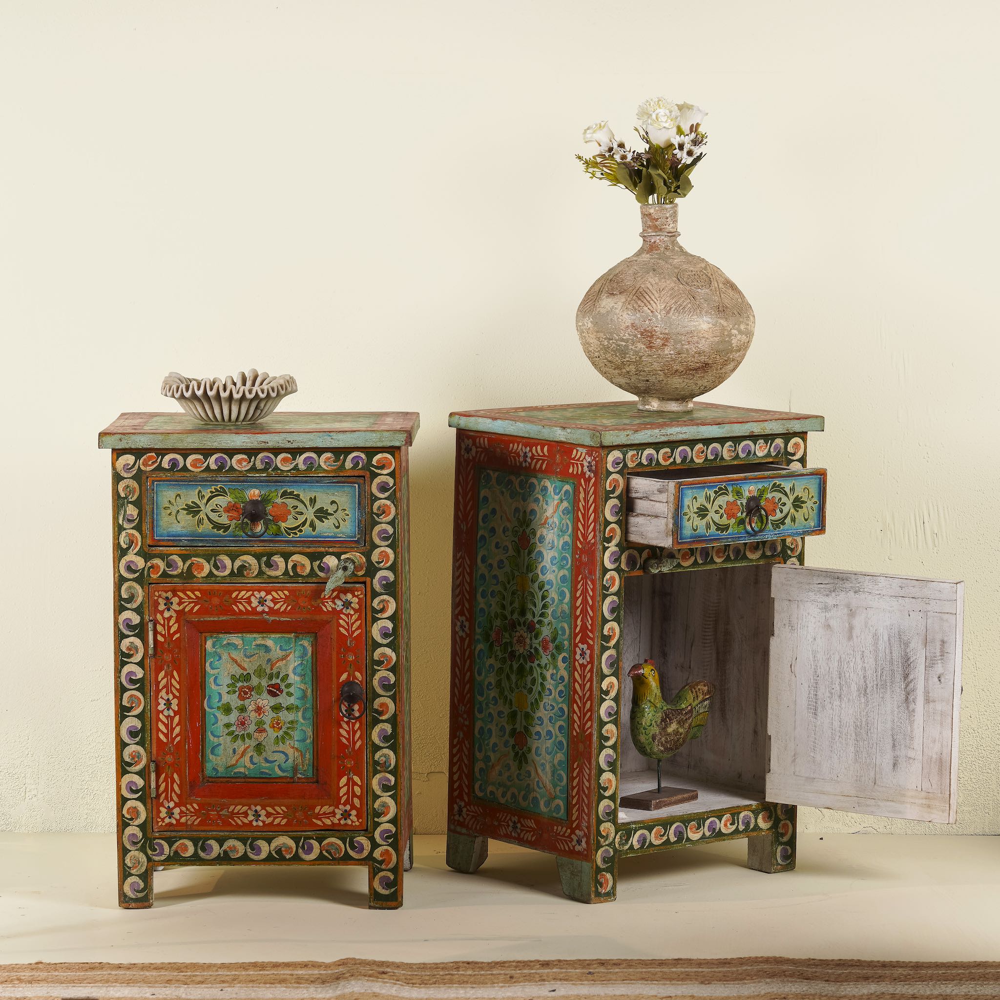 Side angle image with open door of a Hand-painted bedside tables made from recycled wood – vintage night stands with carved mango wood furniture detailing and floral artistry.