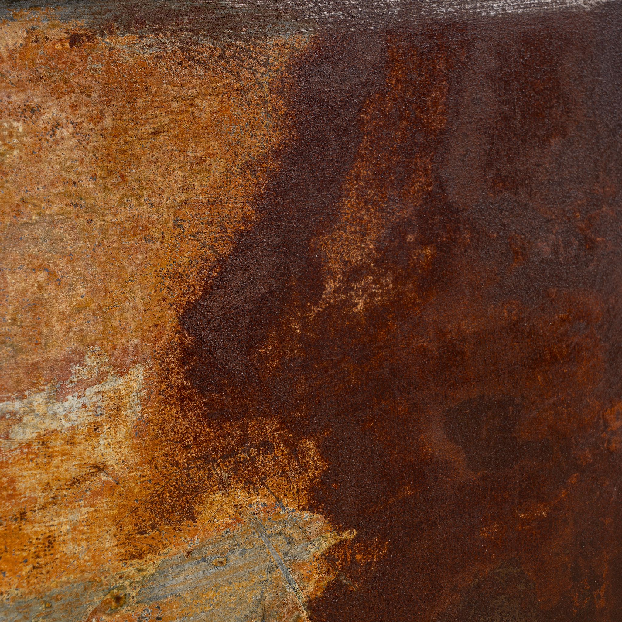Close-up of a rusted iron and teak wall panel, artisanal furniture piece, part of our Indian home decor collection.