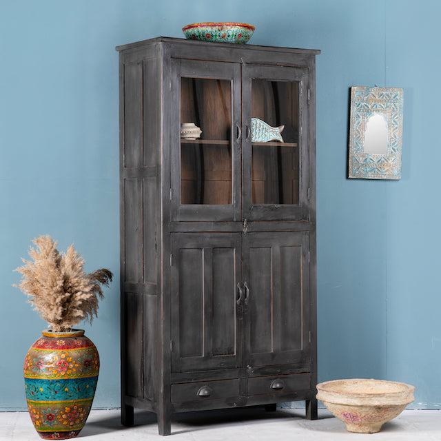 Side angel image of a shabby chic grey teak wood cabinet with glass doors and drawers – sustainable furniture for classic, rustic, or vintage interiors.