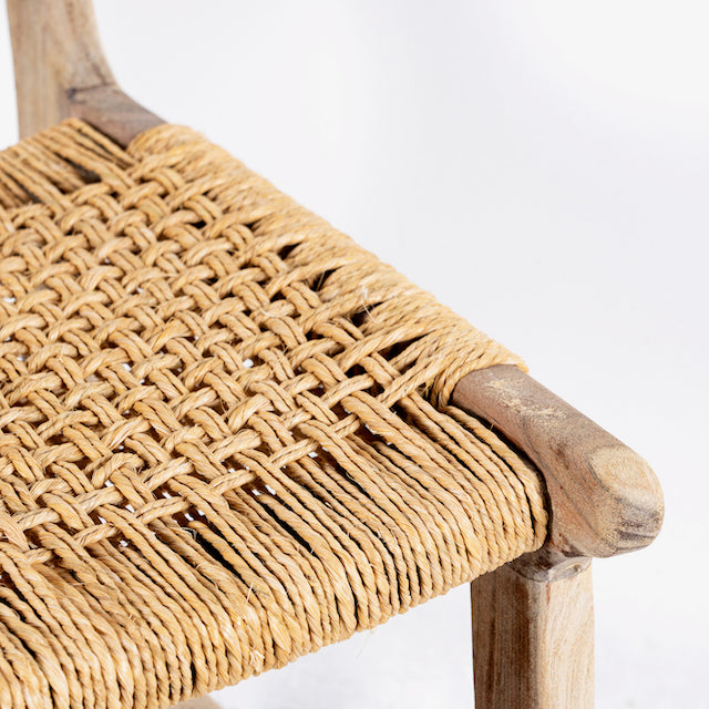 Close up image of a handcrafted Ibiza style wooden chair made from recycled teak with upholstered seat and natural weed canopy, 45 × 50 × 47 cm, backrest height 85 cm.