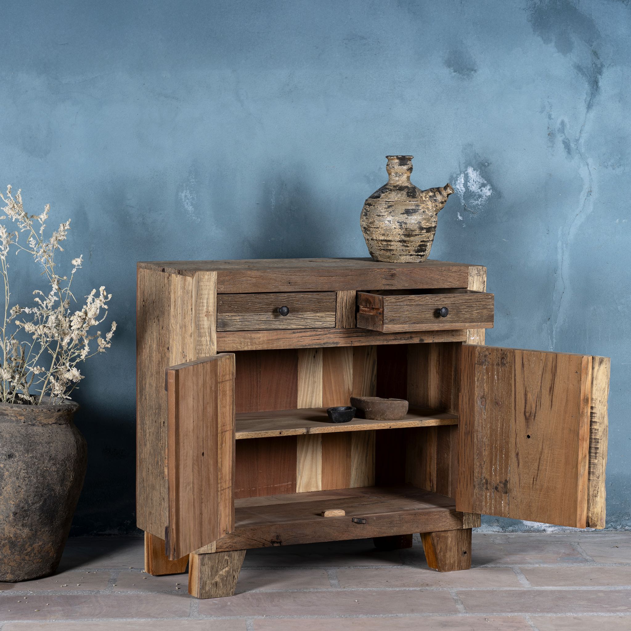 Open door view of a driftwood cabinet made from reclaimed wood with panelled doors, drawers, and rustic finish, 90 × 40 × 90 cm.
