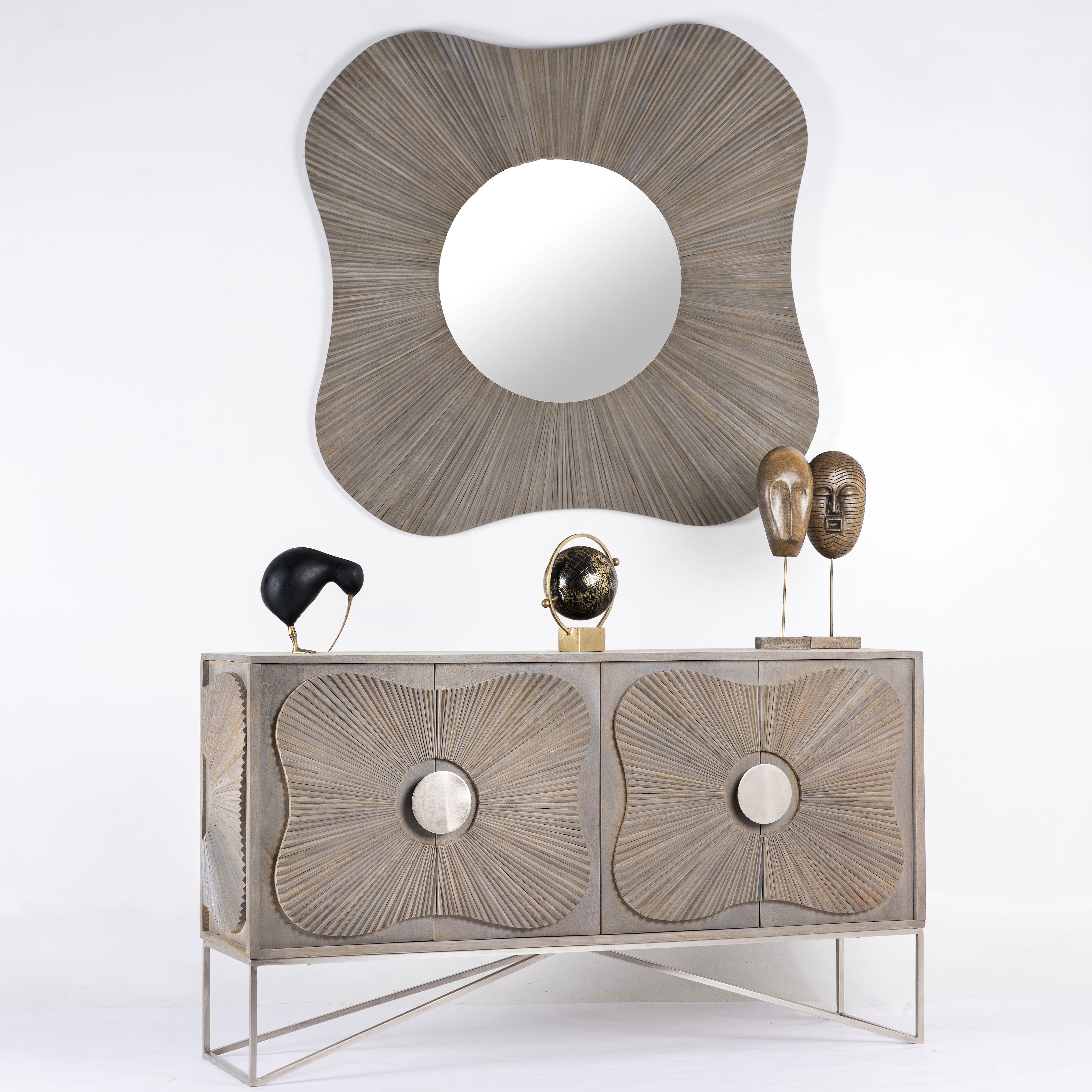 Side angle image of a handcrafted mango wood sideboard with floral-inspired sunburst carving, grey wash finish, and silver accents – mid century style furniture for elegant living spaces.